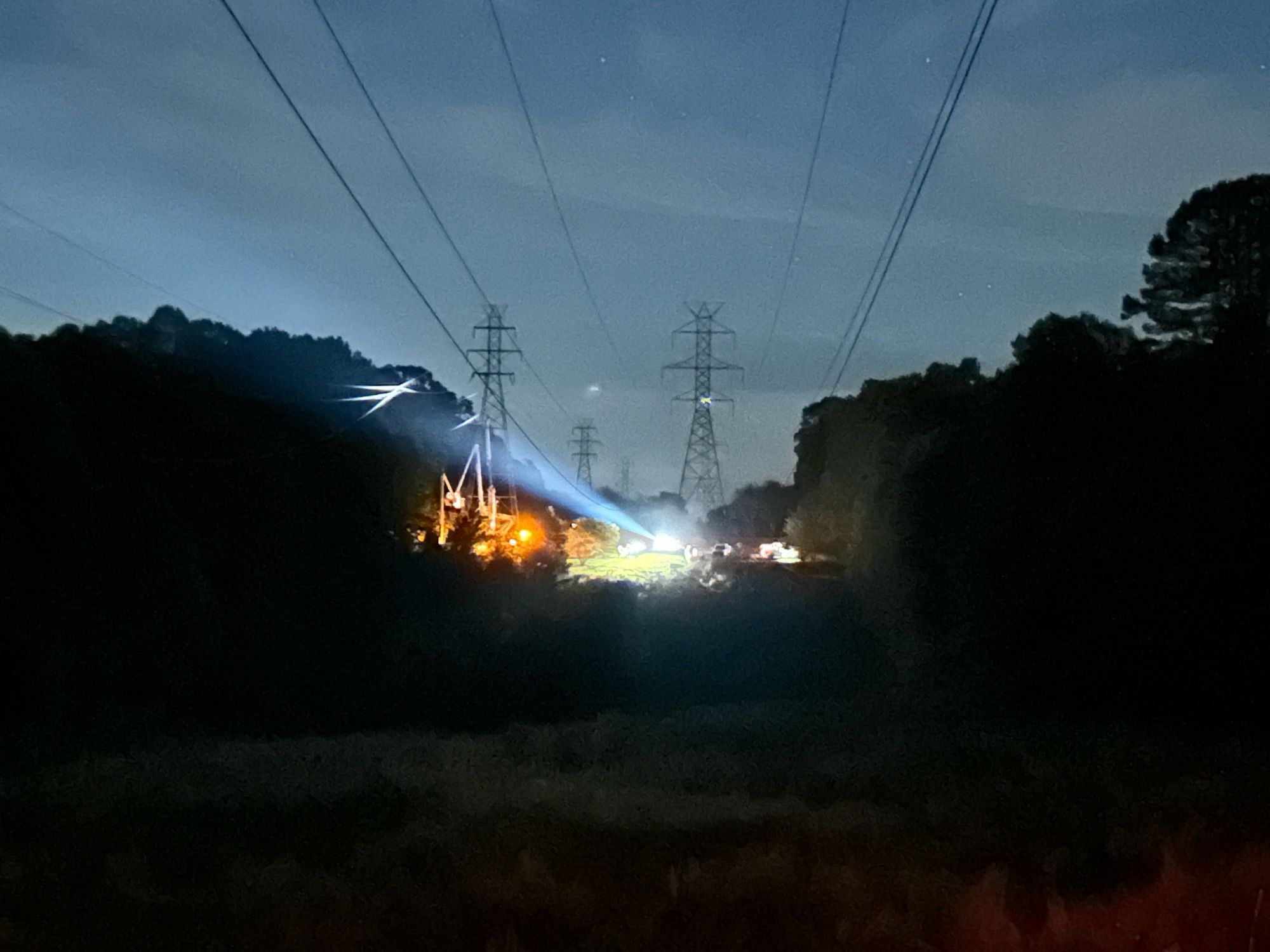 Power crews with spot lights, bucket trucks and other equipment working on fallen high tension power lines after sunset Tuesday Oct.1 as recovery from Hurricane Helene in Upstate SC continues around the clock.