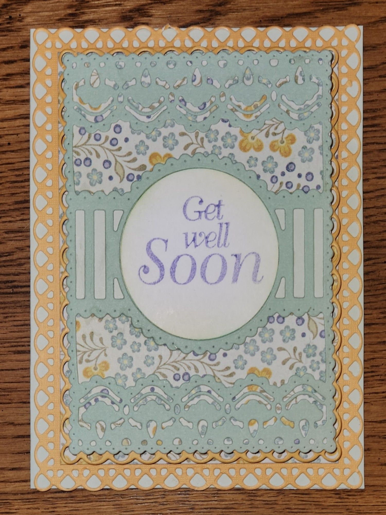 A handmade get well card in mint green, sunflower yellow, and purple.