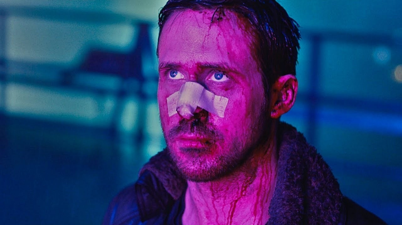 Ryan gosling from bladerunner 2049 looking extremely depressed, covered in blood, scars, bruises, and a prominent nasal bandage.