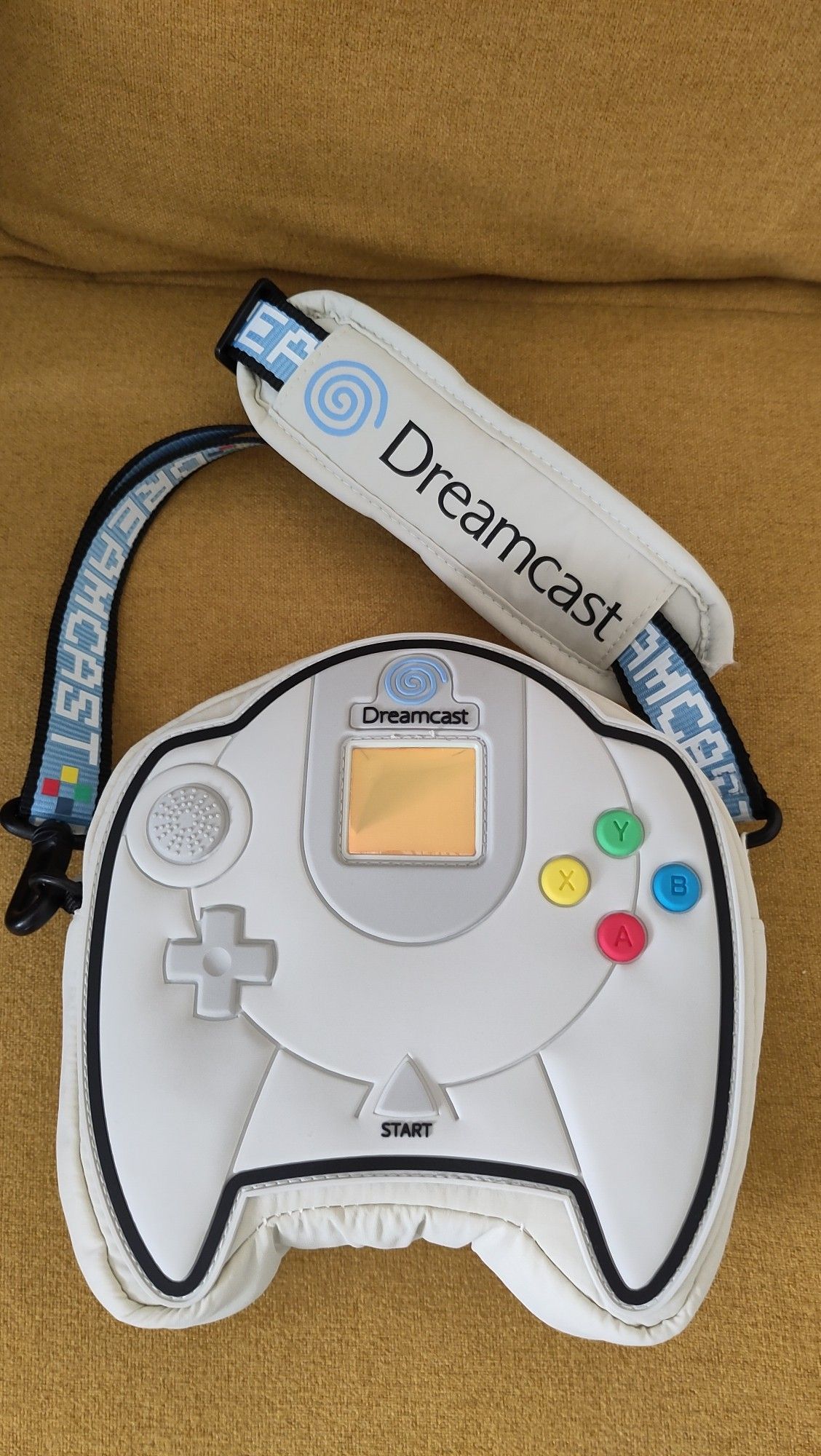 A small bag in the shape of and with the look of a Dreamcast controller