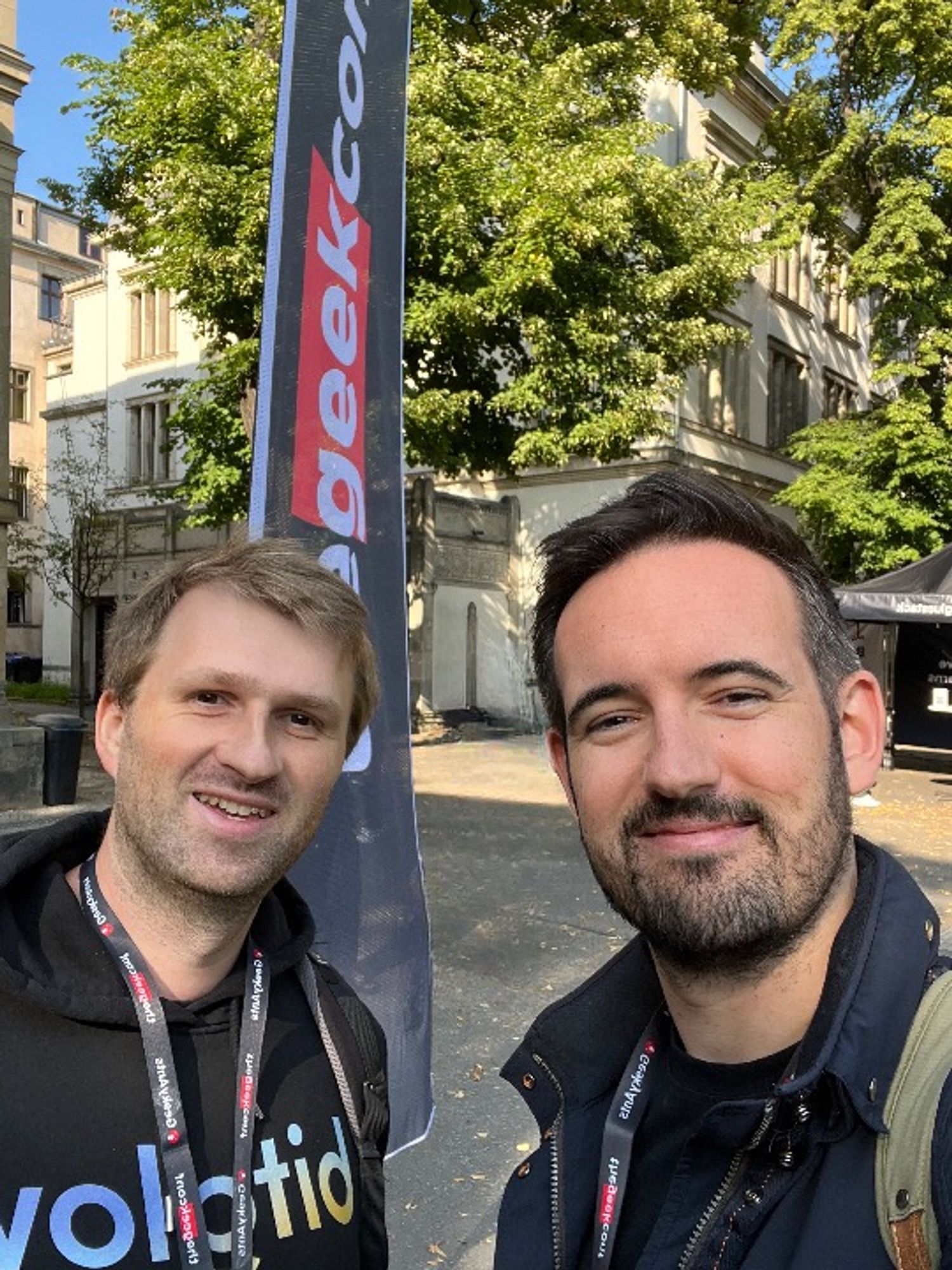 My friend and colleague Jonathan and I in front of a banner of TheGeekConf