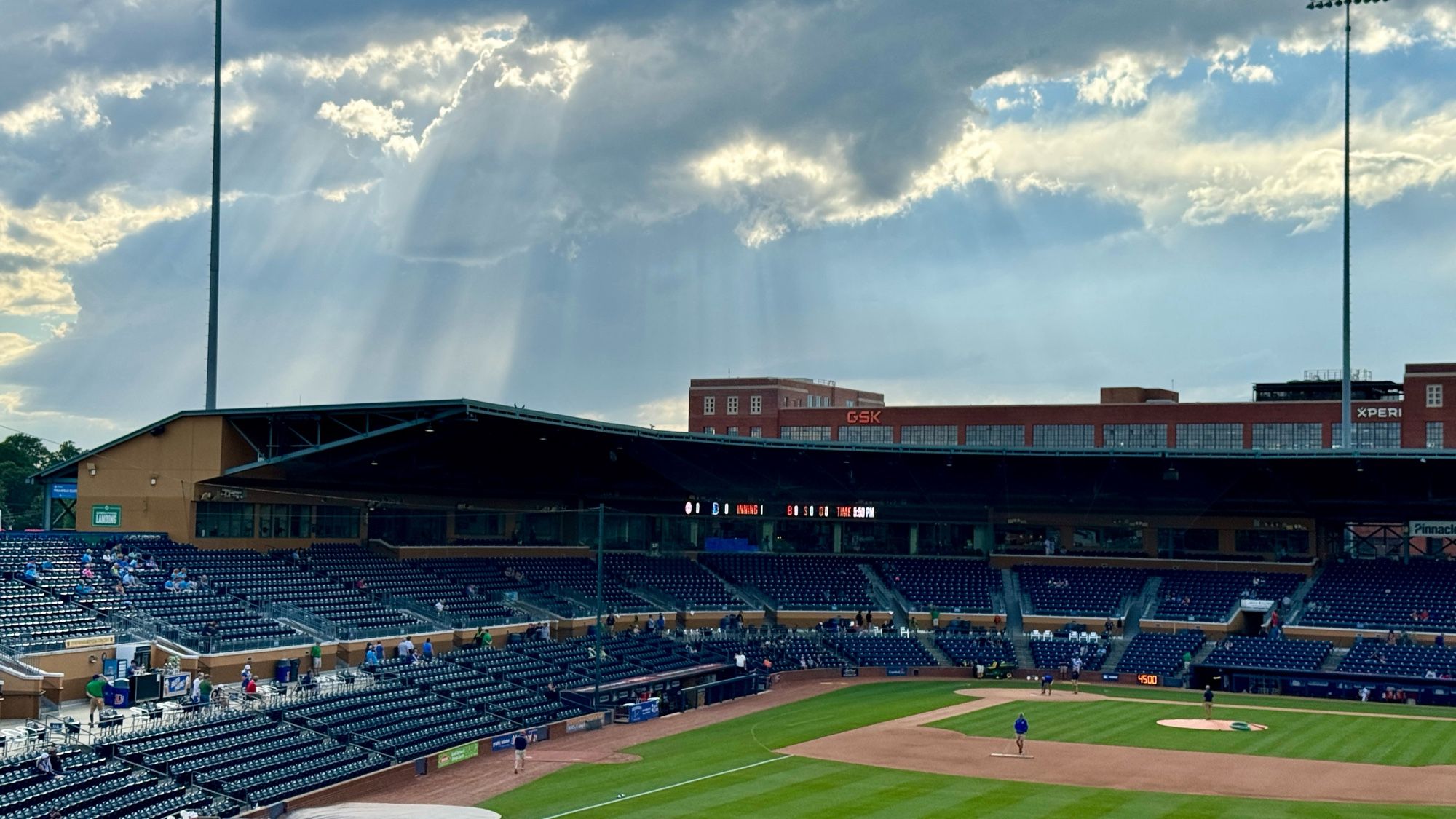 Shafts of sunlight above the Dirham Bulls Athletic Park before a ballgame.