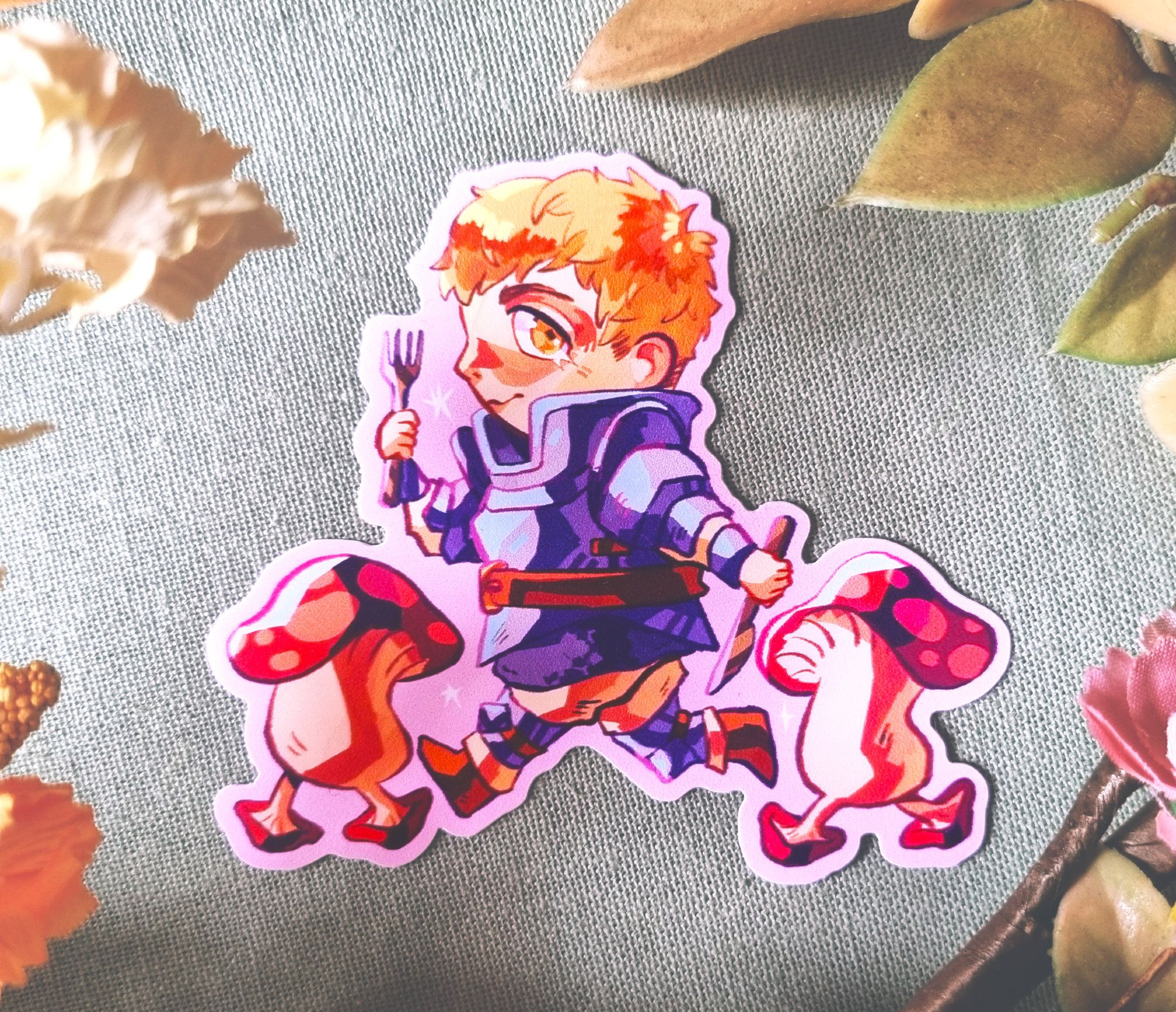 A sticker of Laios from Dungeon Meshi. He is illustrated in a cute chibi style, and is walking alongside two Walking Mushrooms.