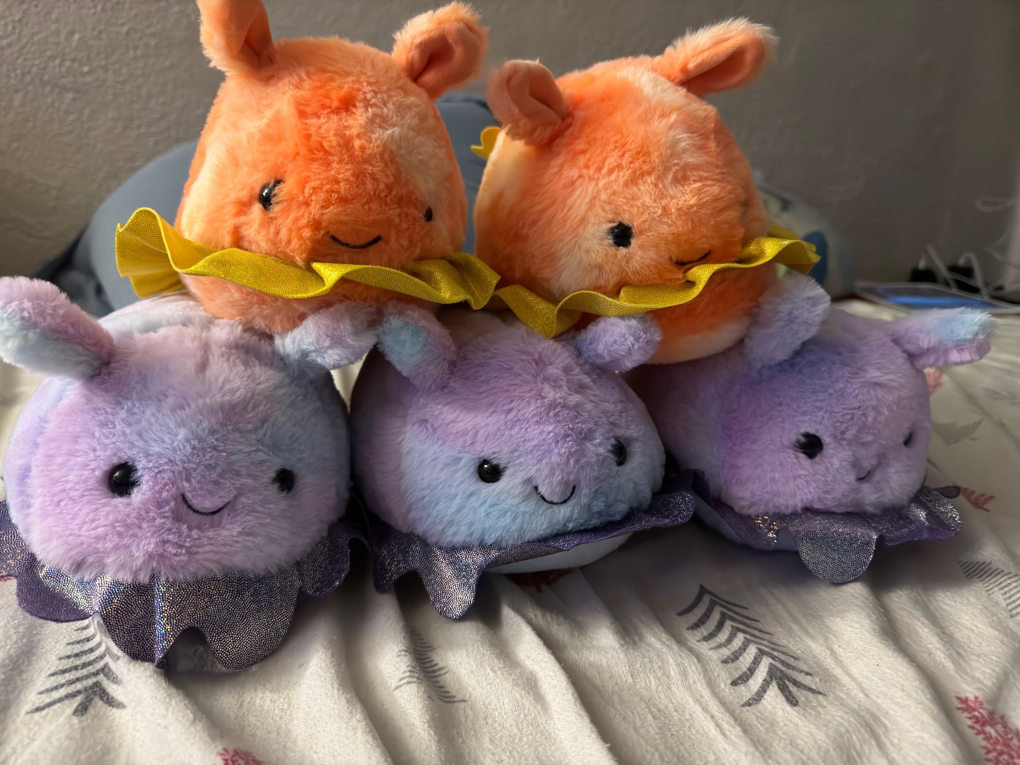 A pyramid of five sea slug stuffies