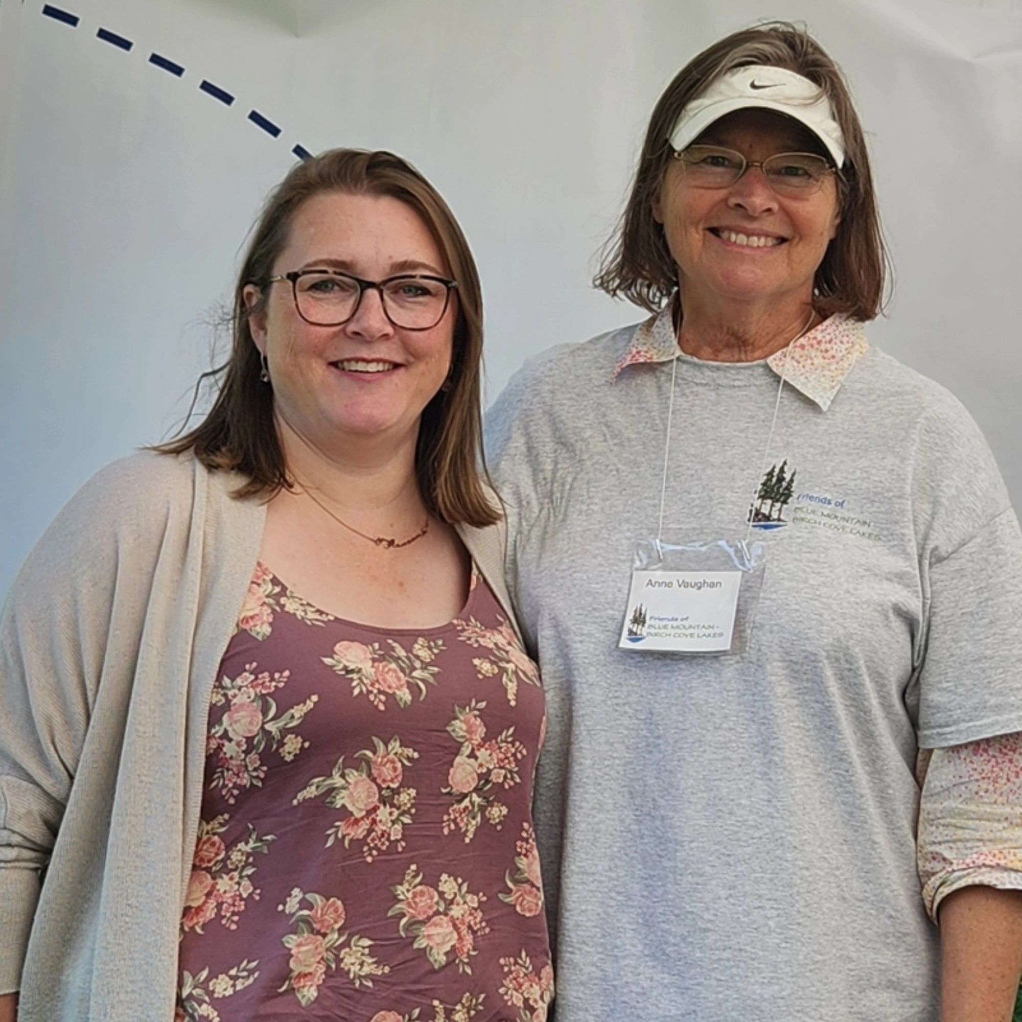 Anita and Anne standing under a white tent.