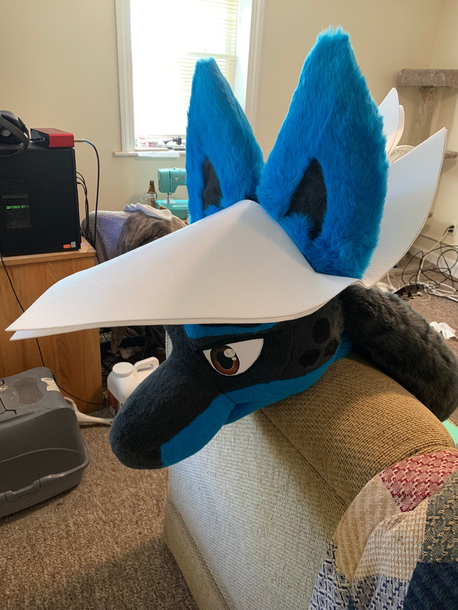 A Lucario fursuit head being sized to the interfacing brim