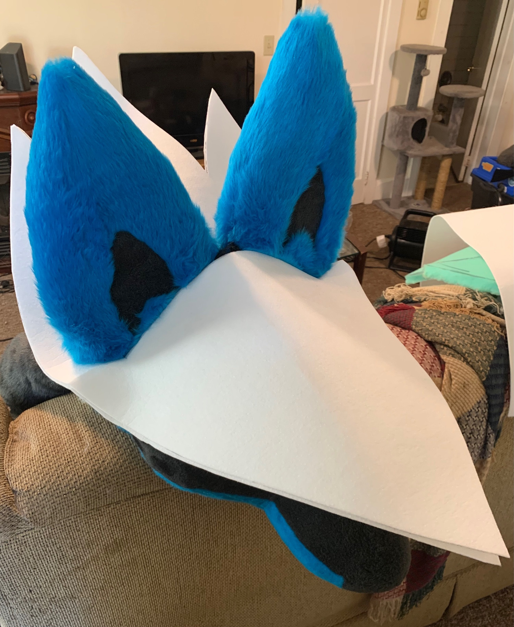 A Lucario fursuit head being sized to the interfacing brim