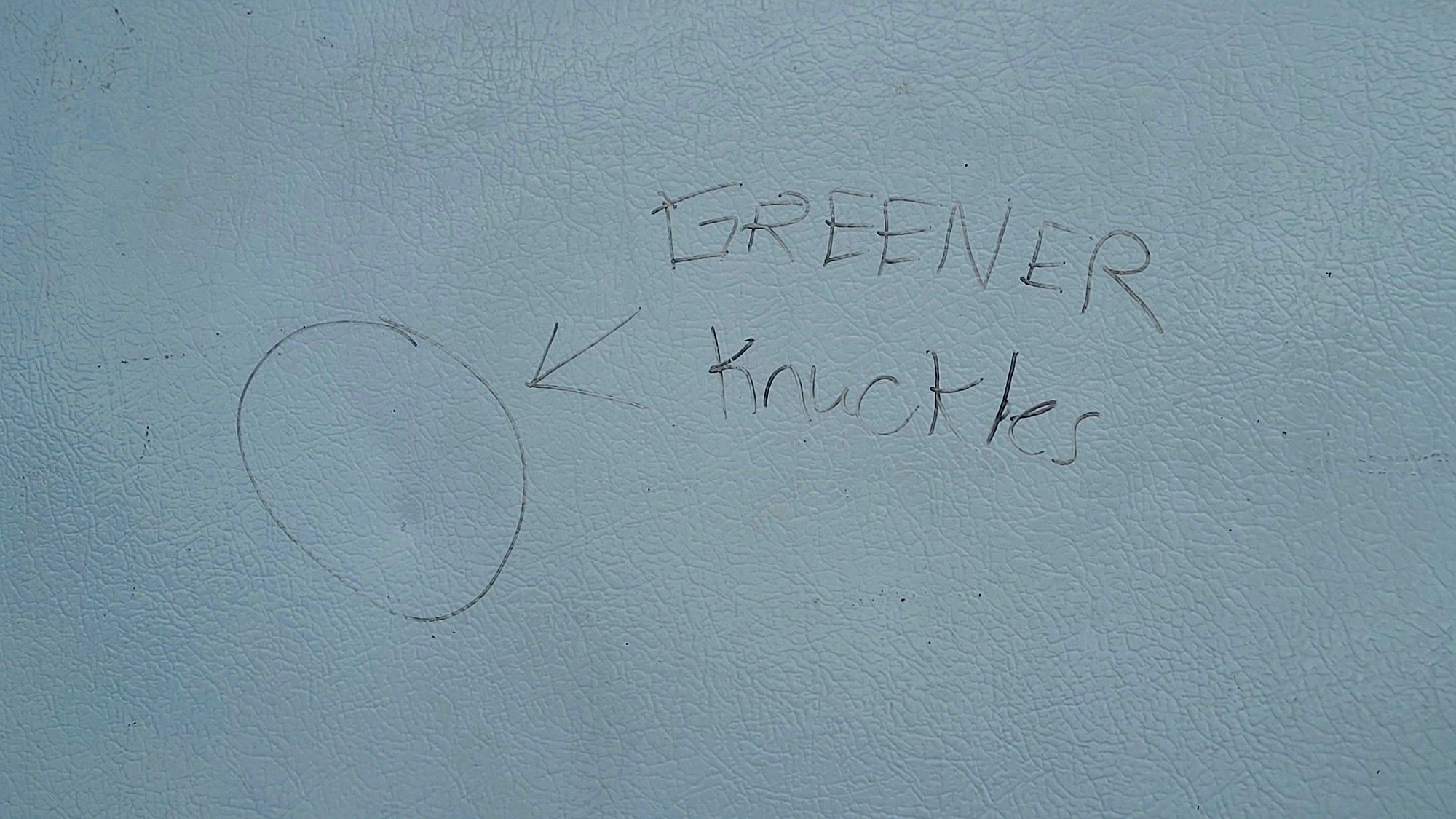 The words "Greener Knuckles", with an arrow pointing to a dent on a fridge