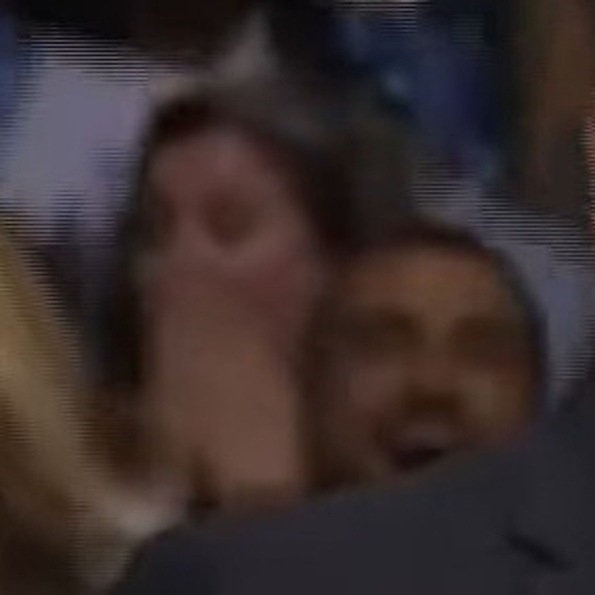 Face of a White female rallygoer behind Tim Walz with her hands over her face gasping.