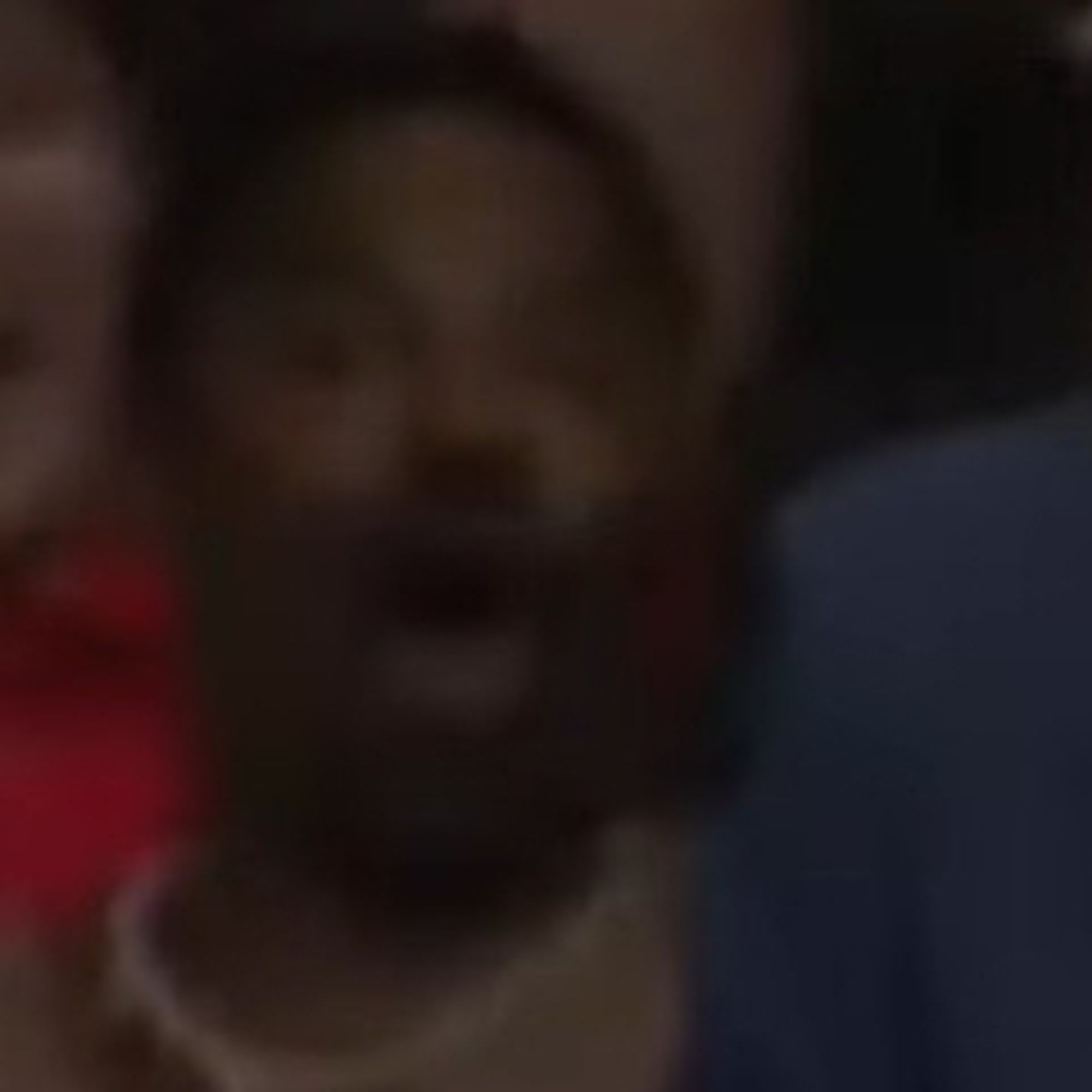 Face of a Black male rallygoer behind Tim Walz with his mouth open as he couldn't believe what Walz just said.