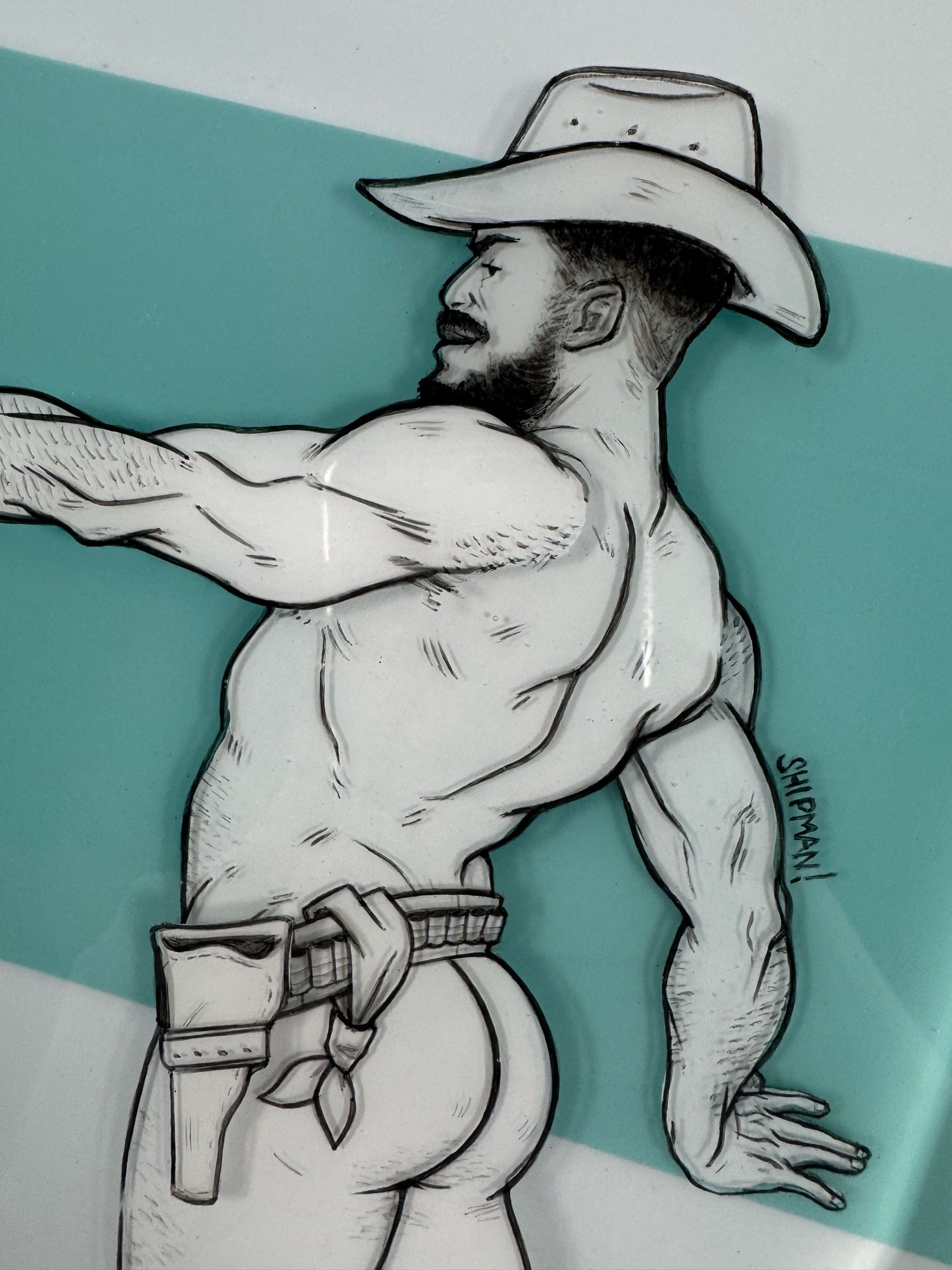 A mixed media resin and acrylic painting. There’s a cowboy facing to the left, left arm outstretched holding a banana like a gun. He’s wearing a cowboy hat, boots and a belt.