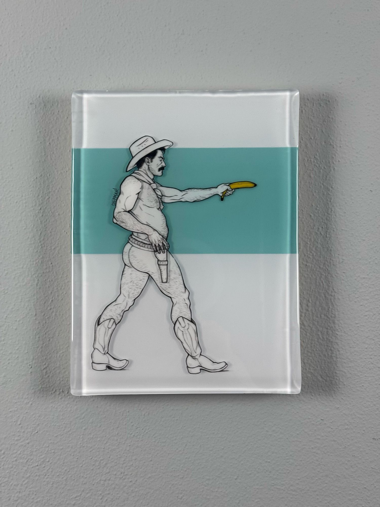 A mixed media resin and acrylic painting. There’s a cowboy facing to the right, left arm outstretched holding a banana. The cowboy is wearing a hat, boots and a belt. Behind him is a horizontal rectangle of Tiffany blue resin.