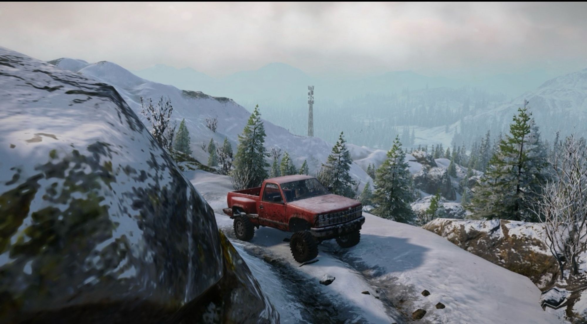 The game “Snowrunner”, with a Chevrolet truck on a snowy road in Alaska, camera angle made to look cinematic