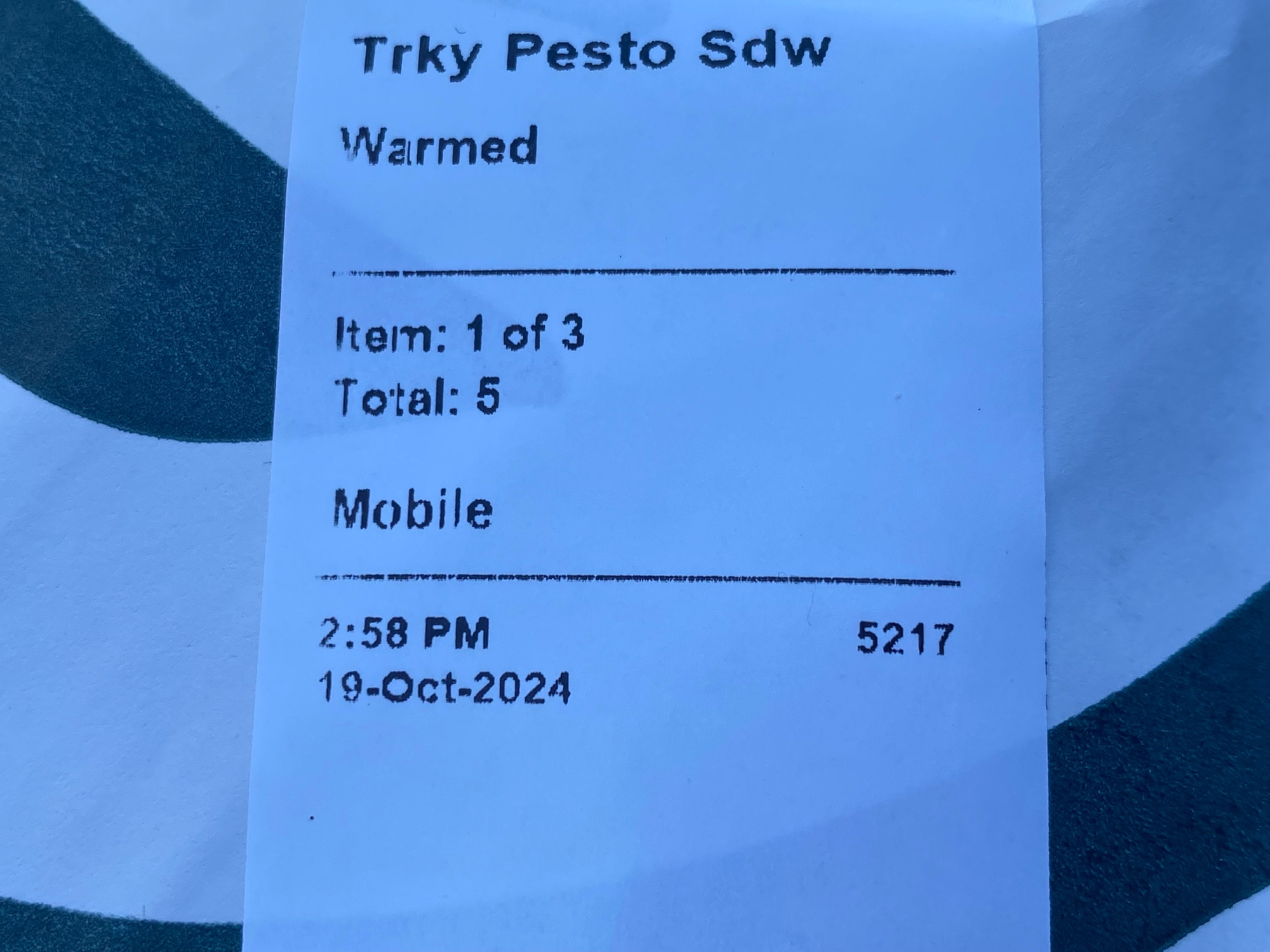 Closeup of sticker on sandwich from Starbucks which reads “Trky Pesto Sdw”