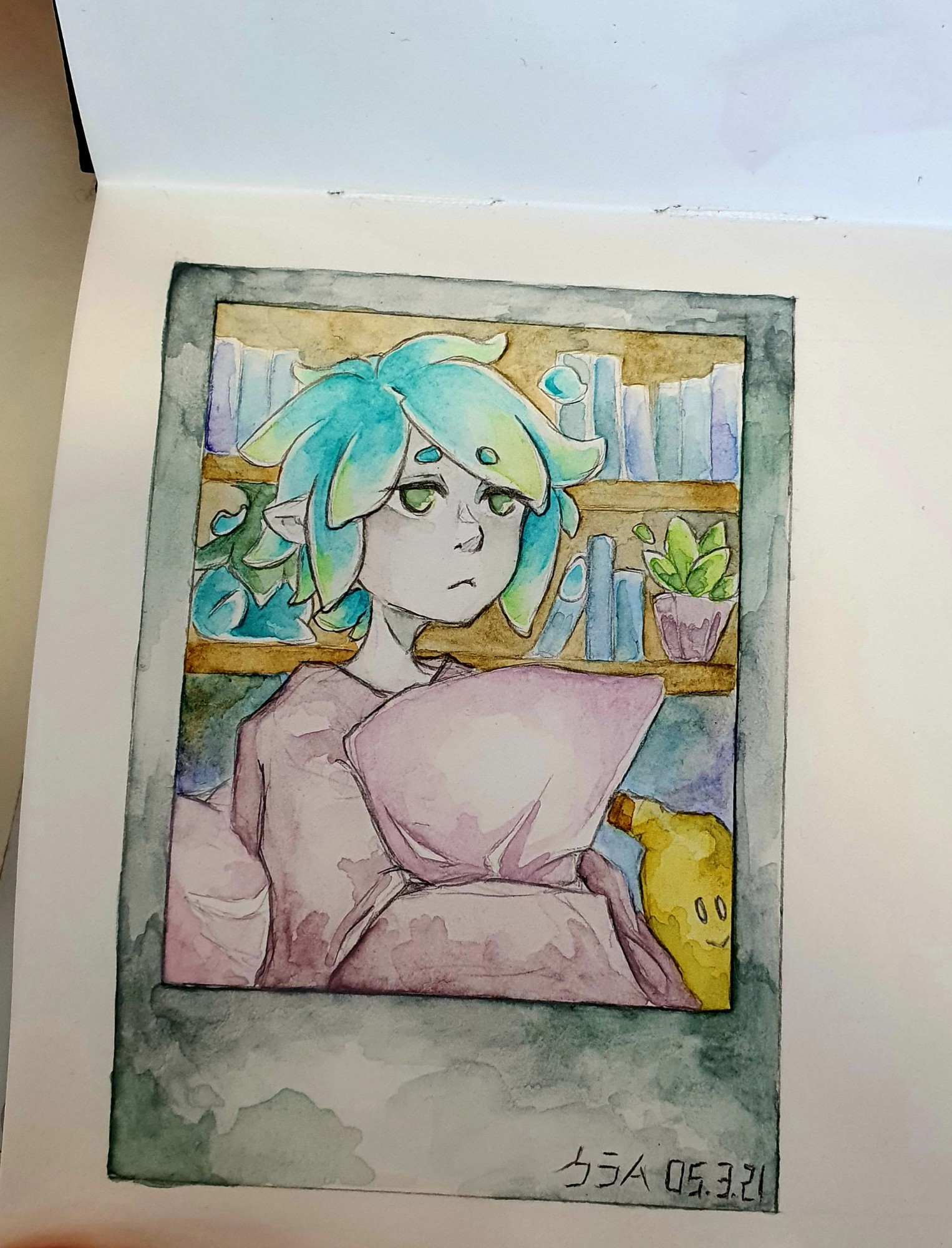 a drawing of a polaroid. a girl covered with a blanket, hugging a pillow. she has blue-green hair, behind her is a little bookshelf and right next to her is a small banana plush