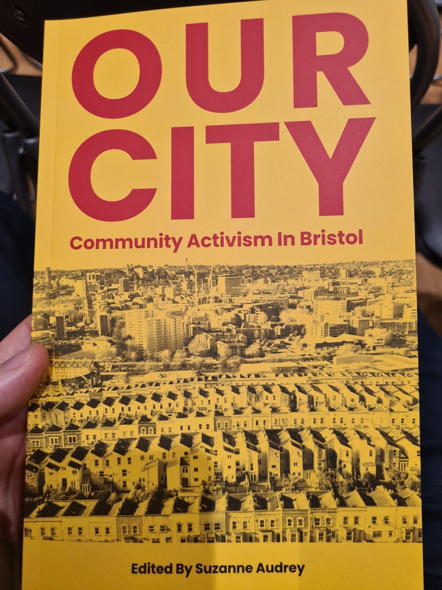 Front page of the book Our City: Community Activism in Bristol edited by Suzanne Audrey with a panoramic photo of Bristol.