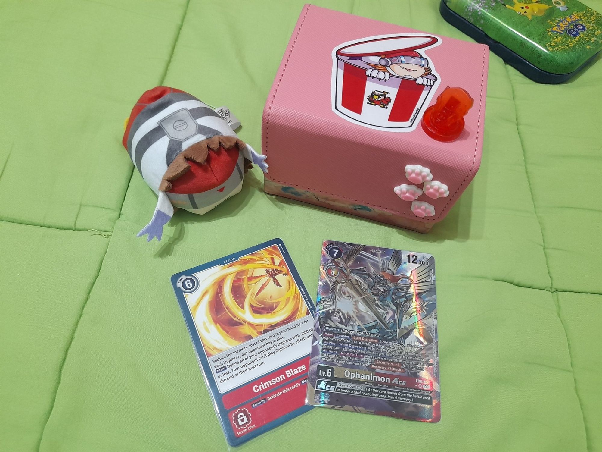 Things on photo: Silphymon odetama, Crimson Blaze card, Ophanimon Ace Alter card (Ophanimon is fighting Lillithmon) and my Silphymon deck with a small transparent red D-3.