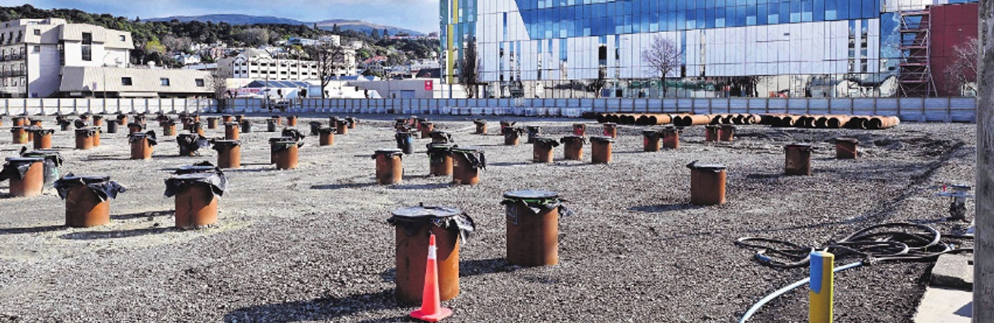 City block sized field of piles driven into reclaimed sediment for foundation