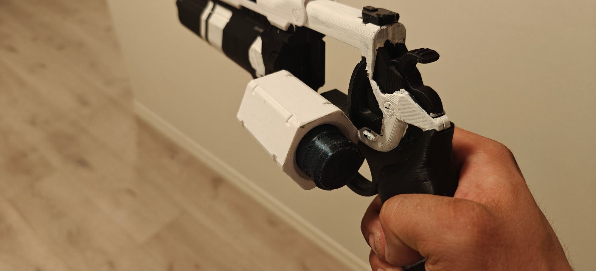 Same 3D printed hand cannon. The breach and chamber has been tilted to the side, and an ammo capsule is halfway loaded into it