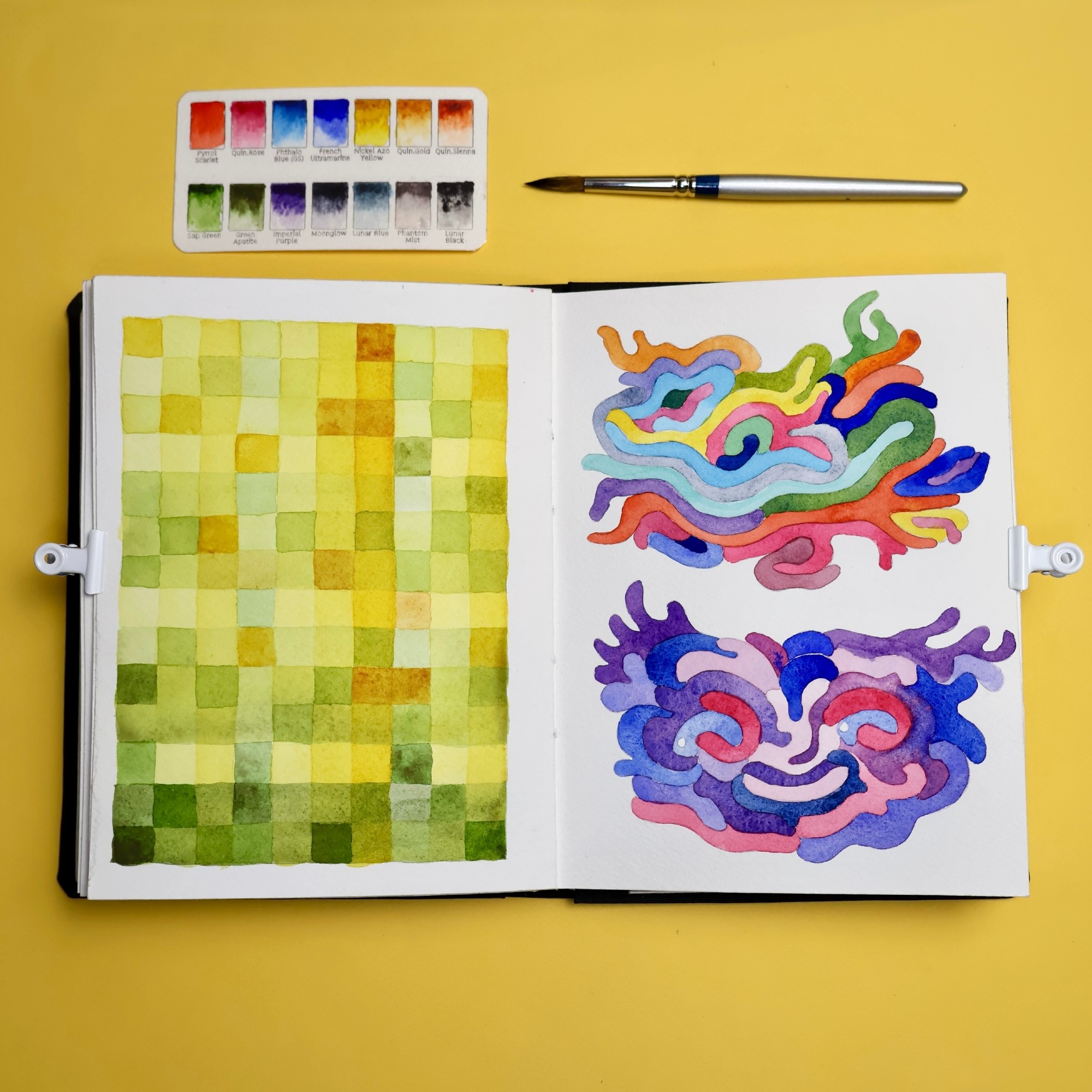 Sketchbook spread with watercolors. A grid of squares on the left and some noodle-like shapes on the right.