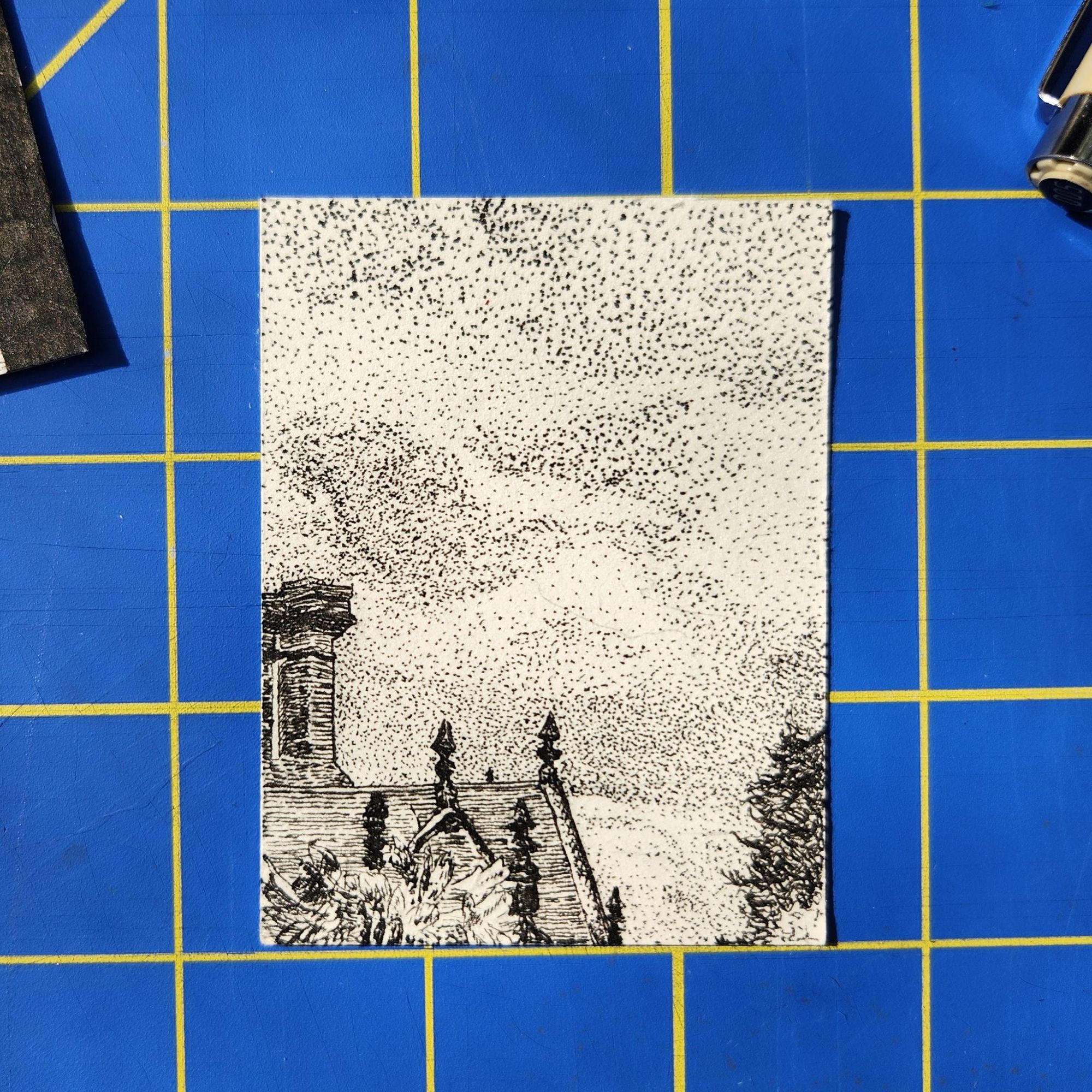 photo of a 2.5" x 3" pen drawing of the corner of a roof in front of a cloudy sky.