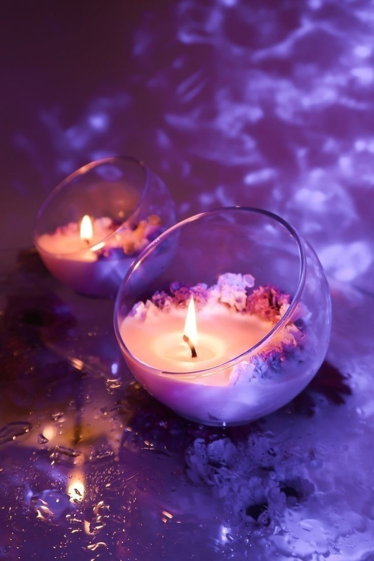 Candles with a fire on in a purple setting