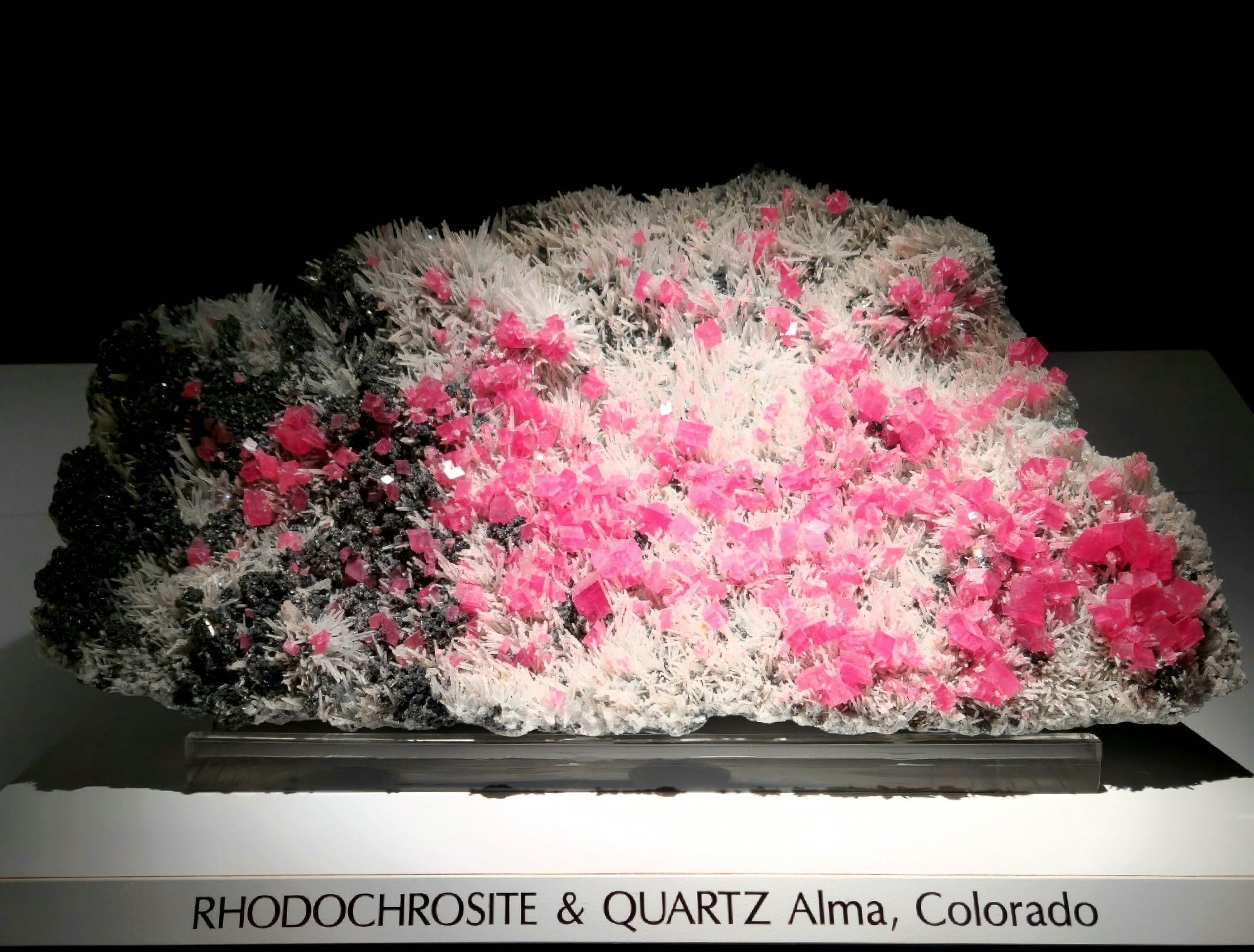 Large rock with black sphalerite nodules, white quartz spires and pink rhombohedral rhodochrosite.
Display notation: RHODOCHROSITE & QUARTZ Alma, Colorado