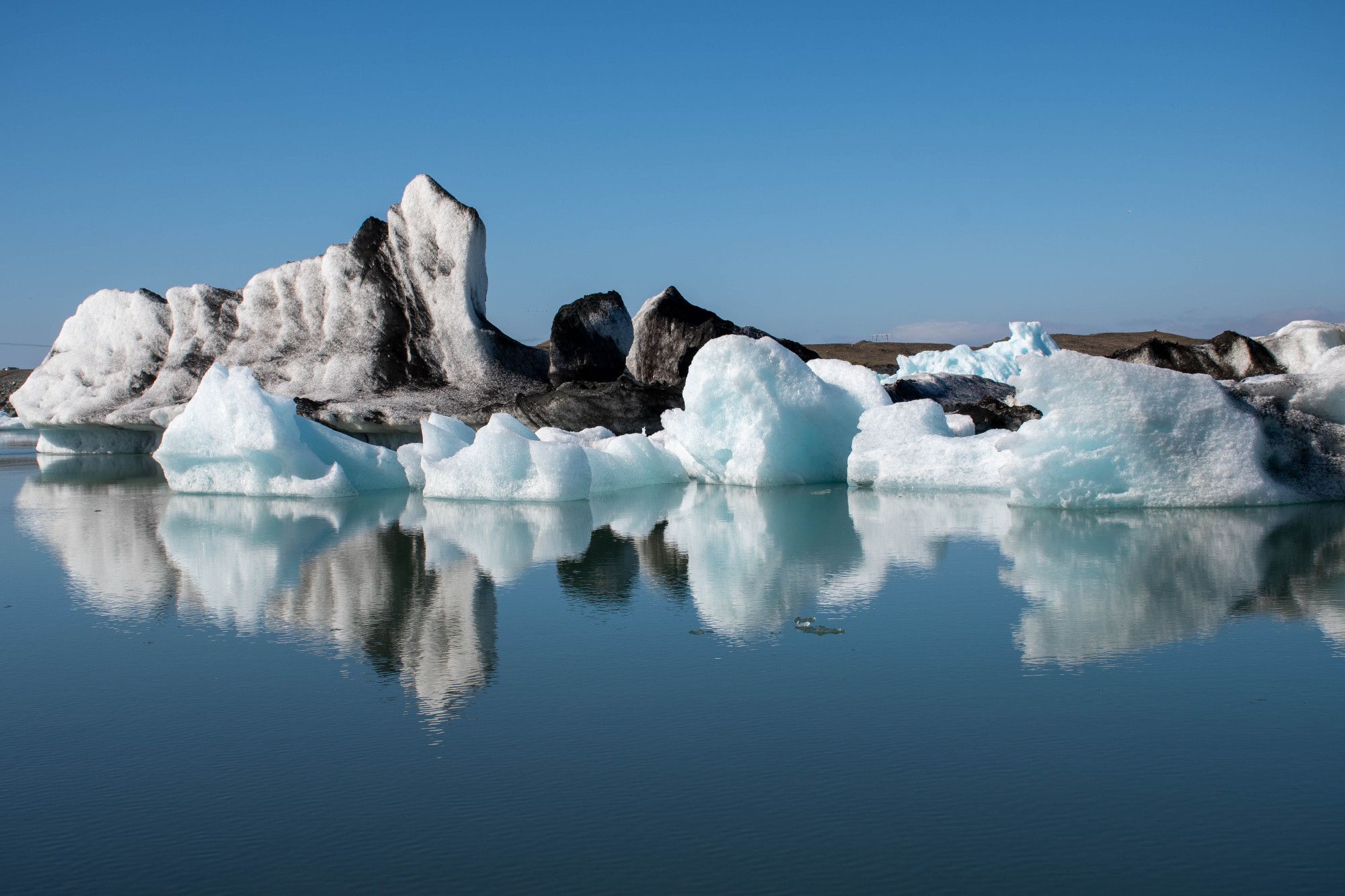 Ice sculptures floating in a glacier lagoon with reflections