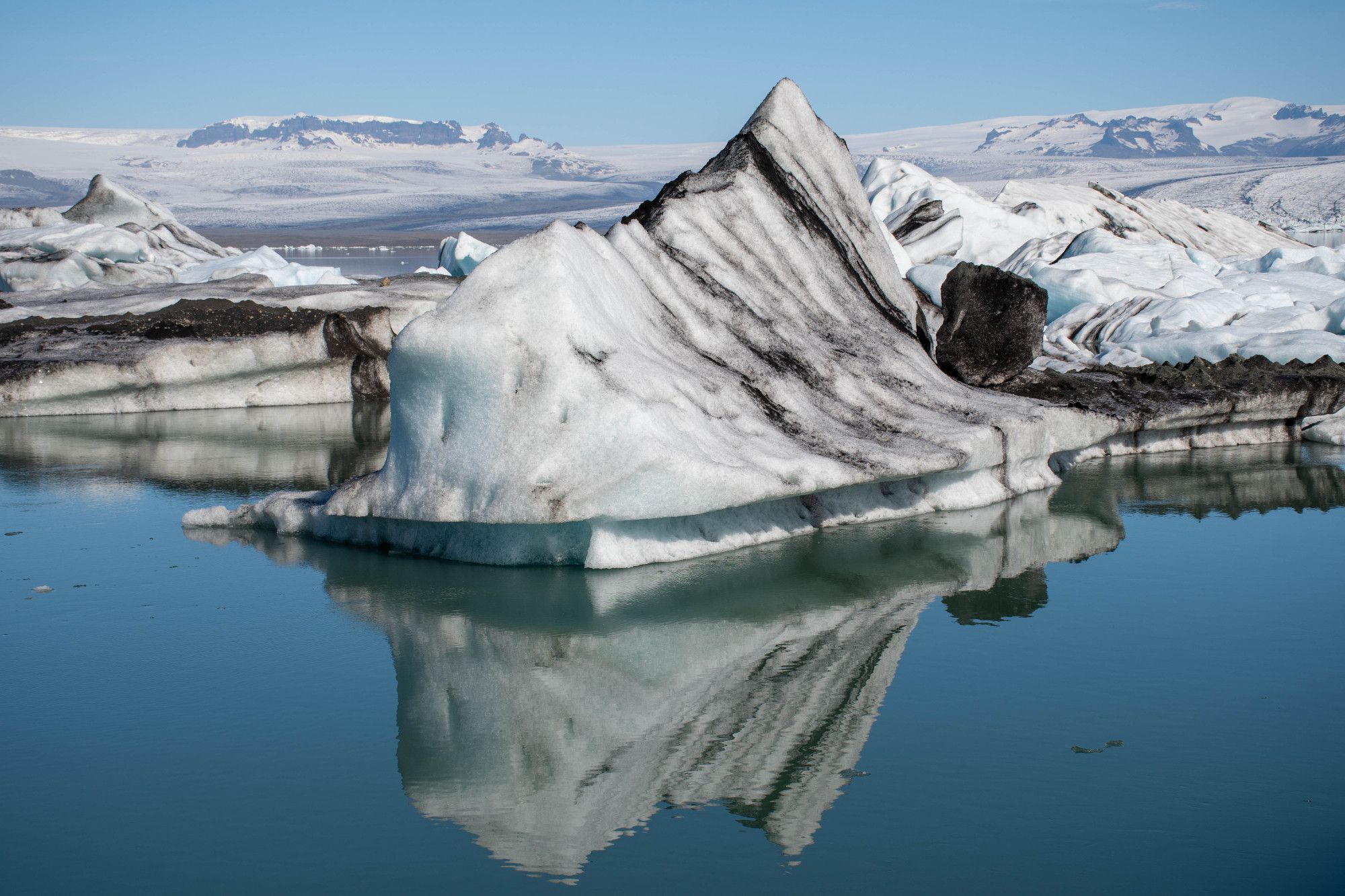 Ice sculptures floating in a glacier lagoon with reflections