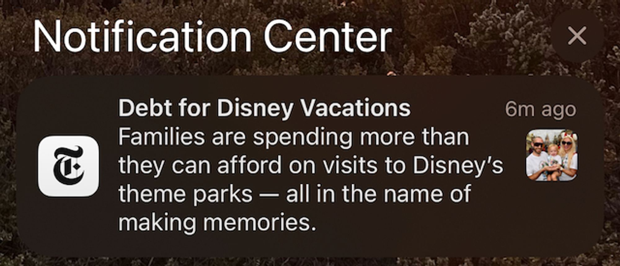 Phone screenshot of NYT notification saying "Debt for Disney Vacations: Families are spending more than they can afford on visits to Disney's theme parks – all in the name of making memories"