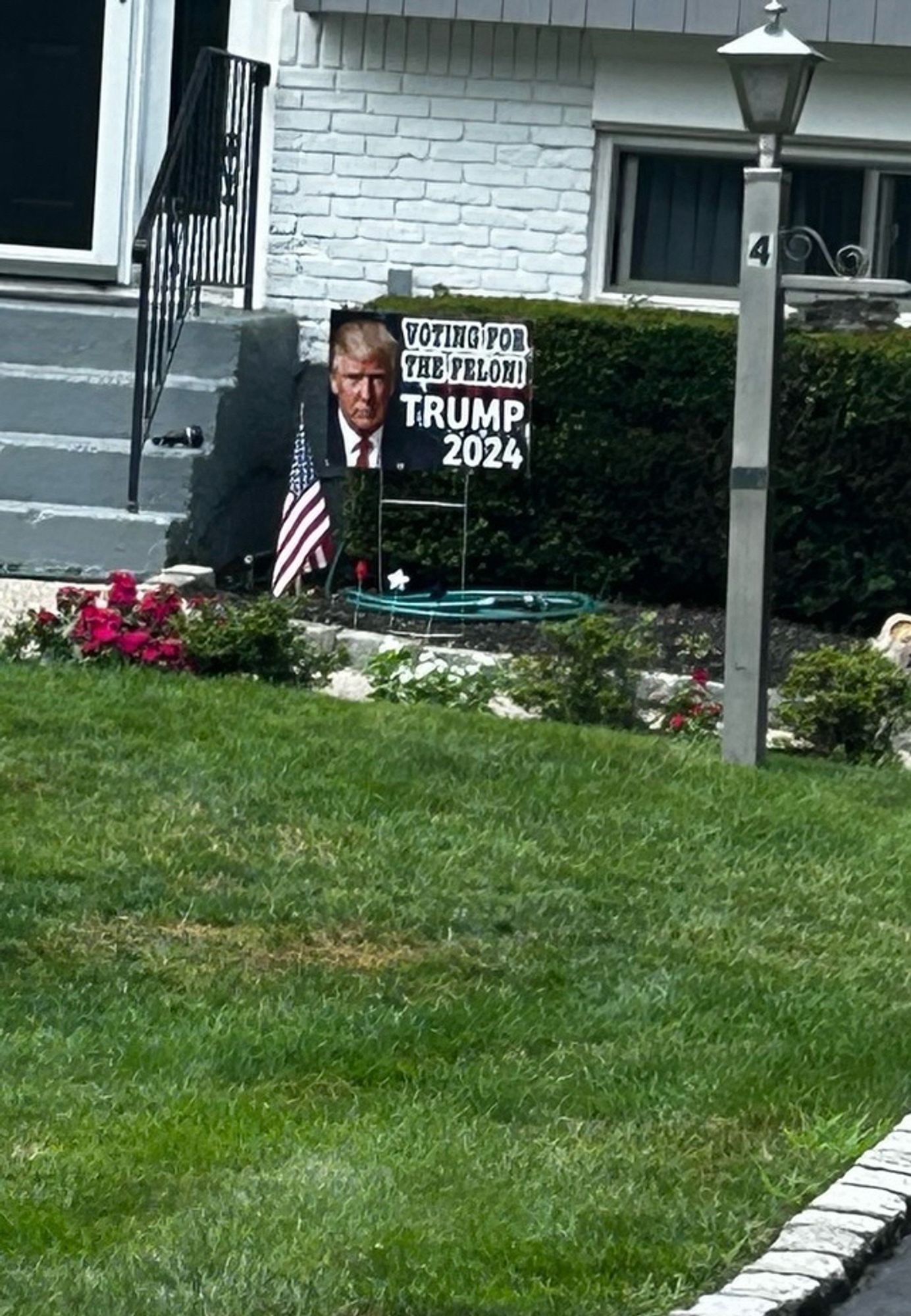 Lawn sign: Voting for the felon. Trump 2024