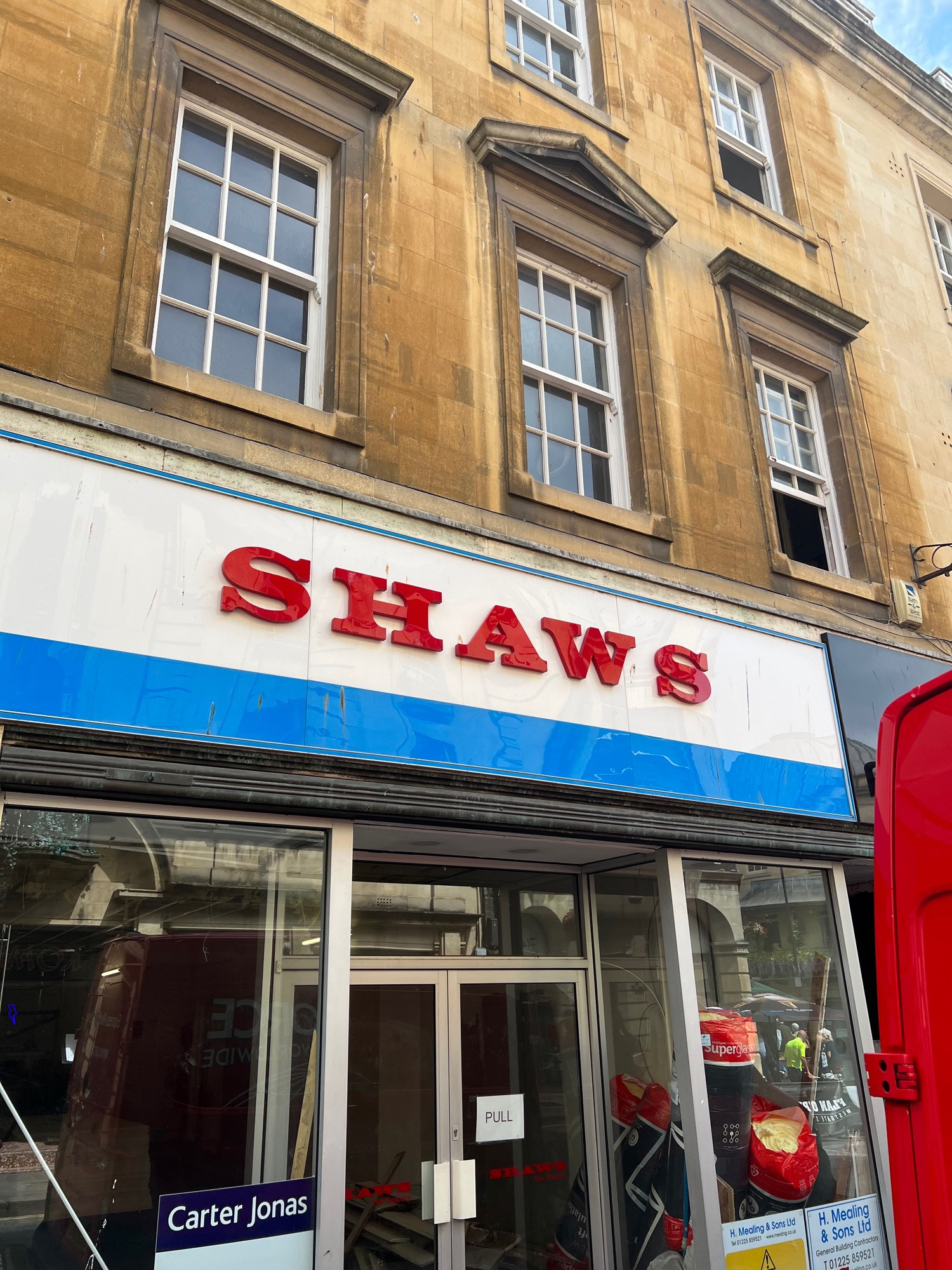 An empty shopfront in Bath, UK, which uses similar colours and styling to Jaws, but is called ‘Shaws’