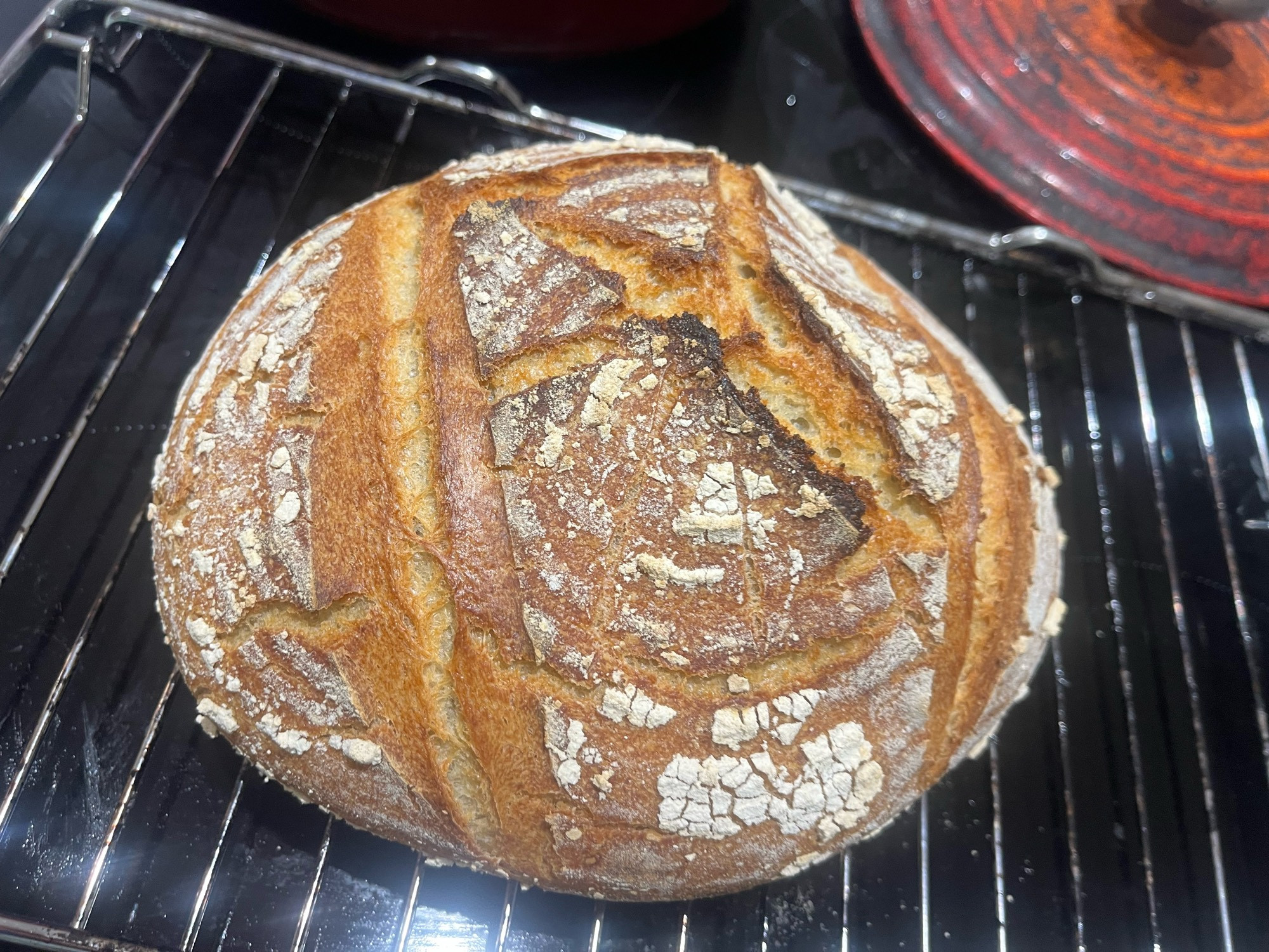 Load of sourdough, pleasingly brown, cooling on a wire rack 