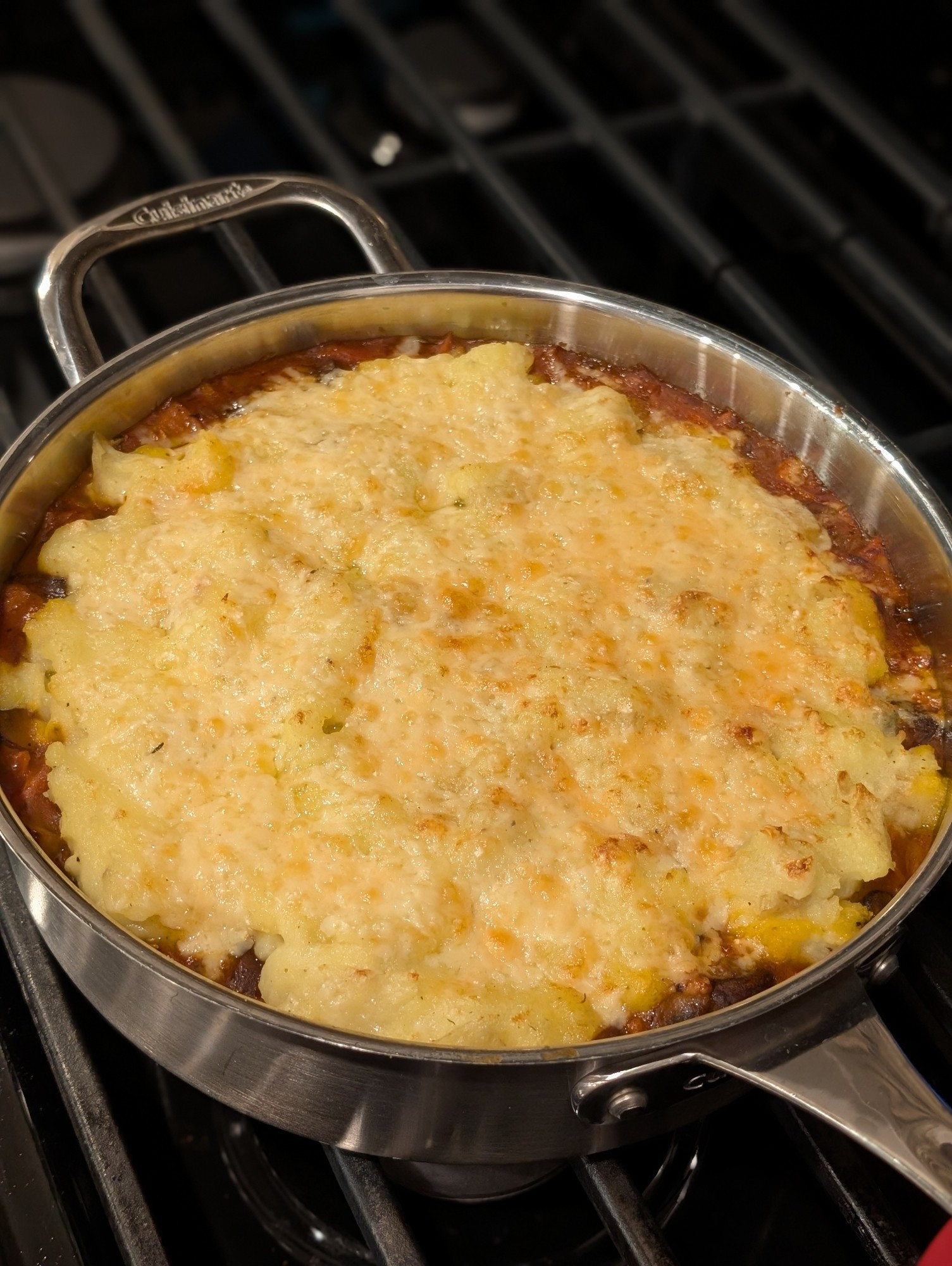 A rich brown shepherds pie, covered in mashed potatoes, and finished with cheddar under the broiler until it just starts to brown.