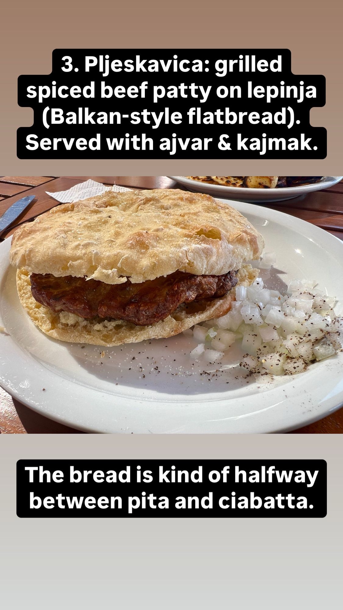 A “Balkan burger” — meat patty on bread! Chopped onions on the side.