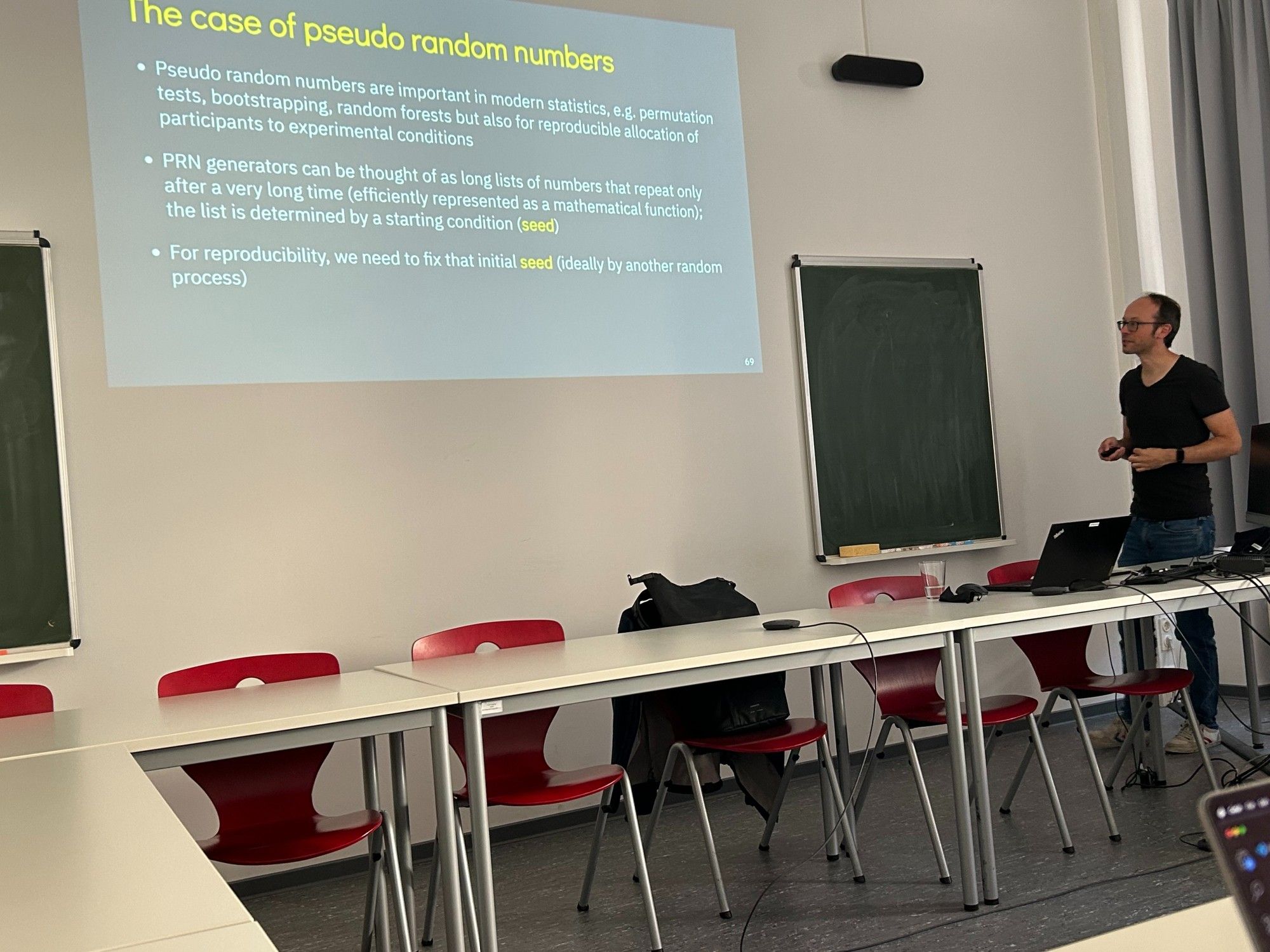 Andreas Brandmaier in front of a slide titled "The case of pseudo random numbers"