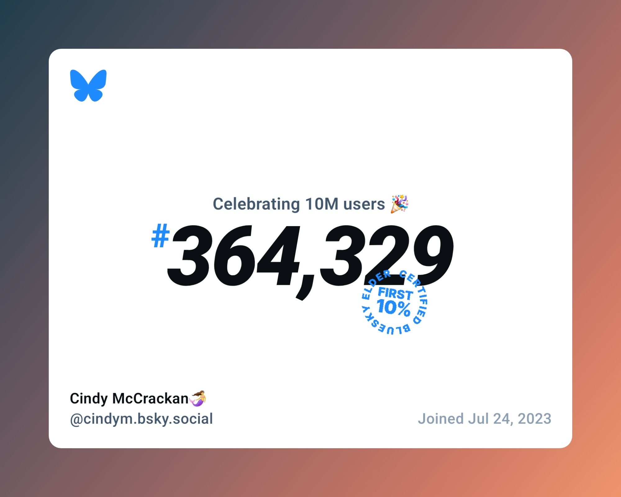 A  brown-ombre edged card with a white printed surface, black printed text reads: Celebrating 10 m users celebration emoji #364, 329 with a blue stamp that shows this number is in the first 10% of users for Cindy McCrackan at cindym.bsky.social. joined July 24th 2023