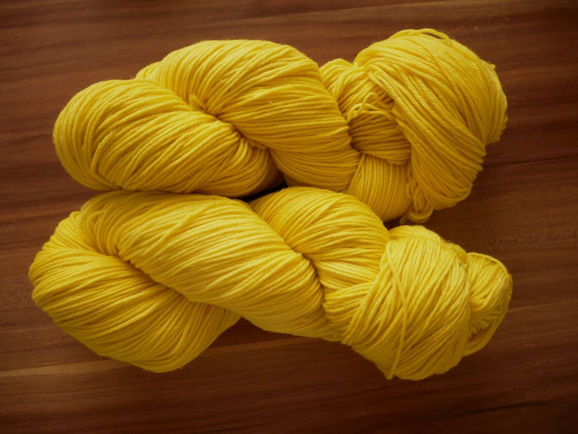 two skeins of bright yellow yarn