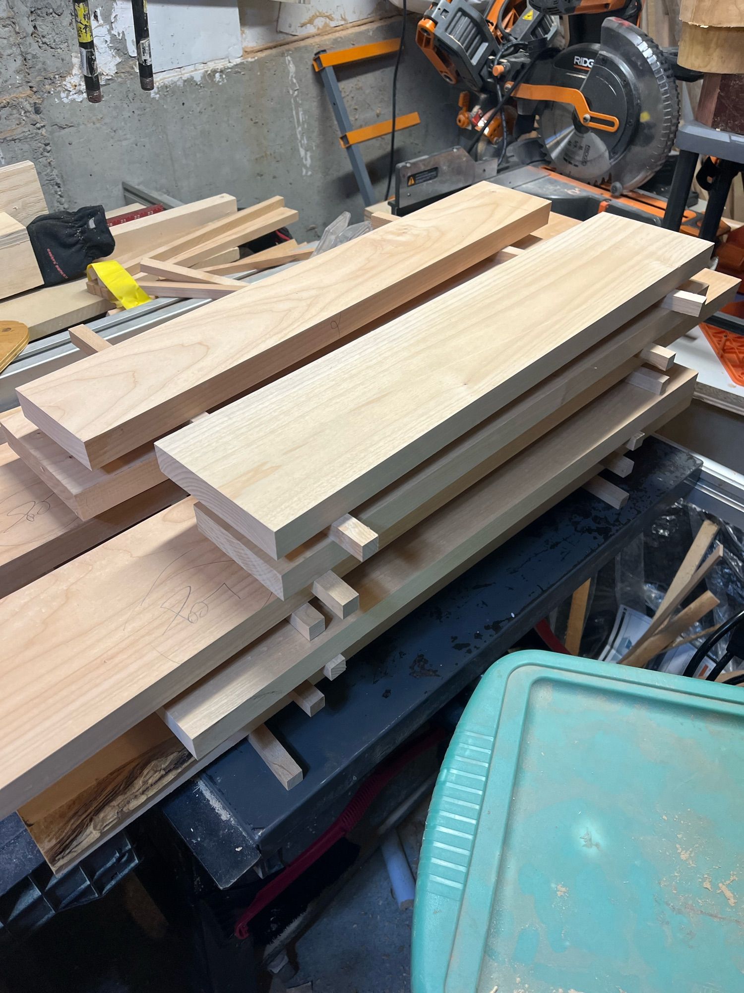 Pieces of milled maple stacked with small sticks between each layer.