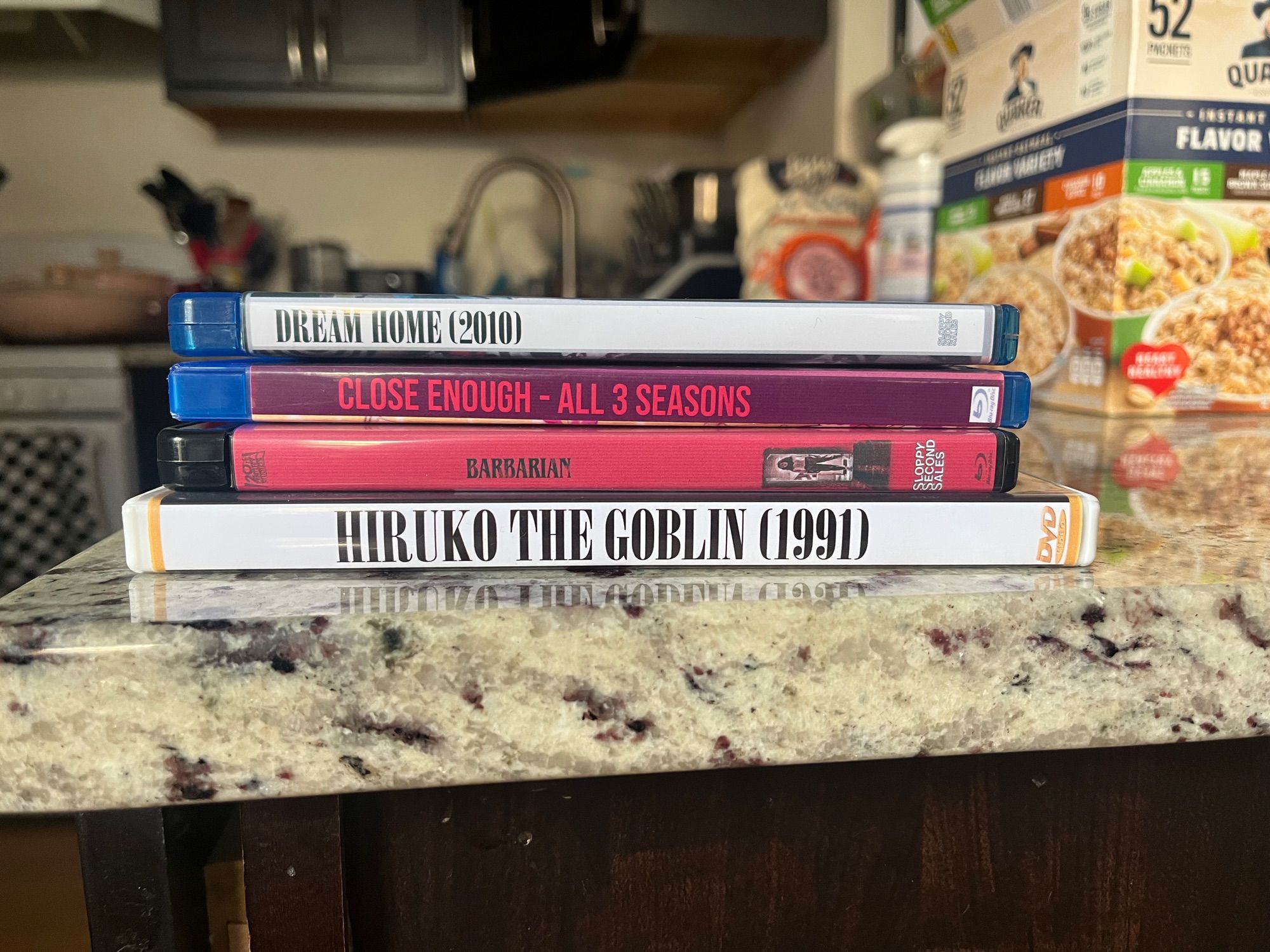 a DVD of HIRUKO THE GOBLIN, and blu rays of CLOSE ENOUGH, BARBARIAN, and DREAM HOME on my kitchen counter 