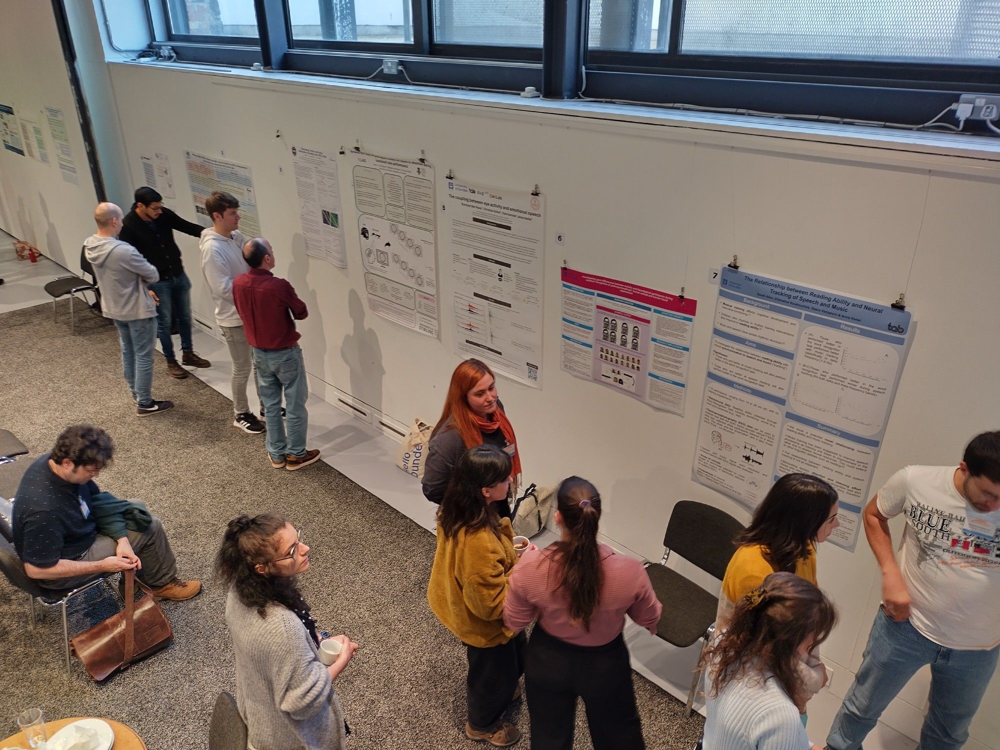 People viewing and discussing research posters.