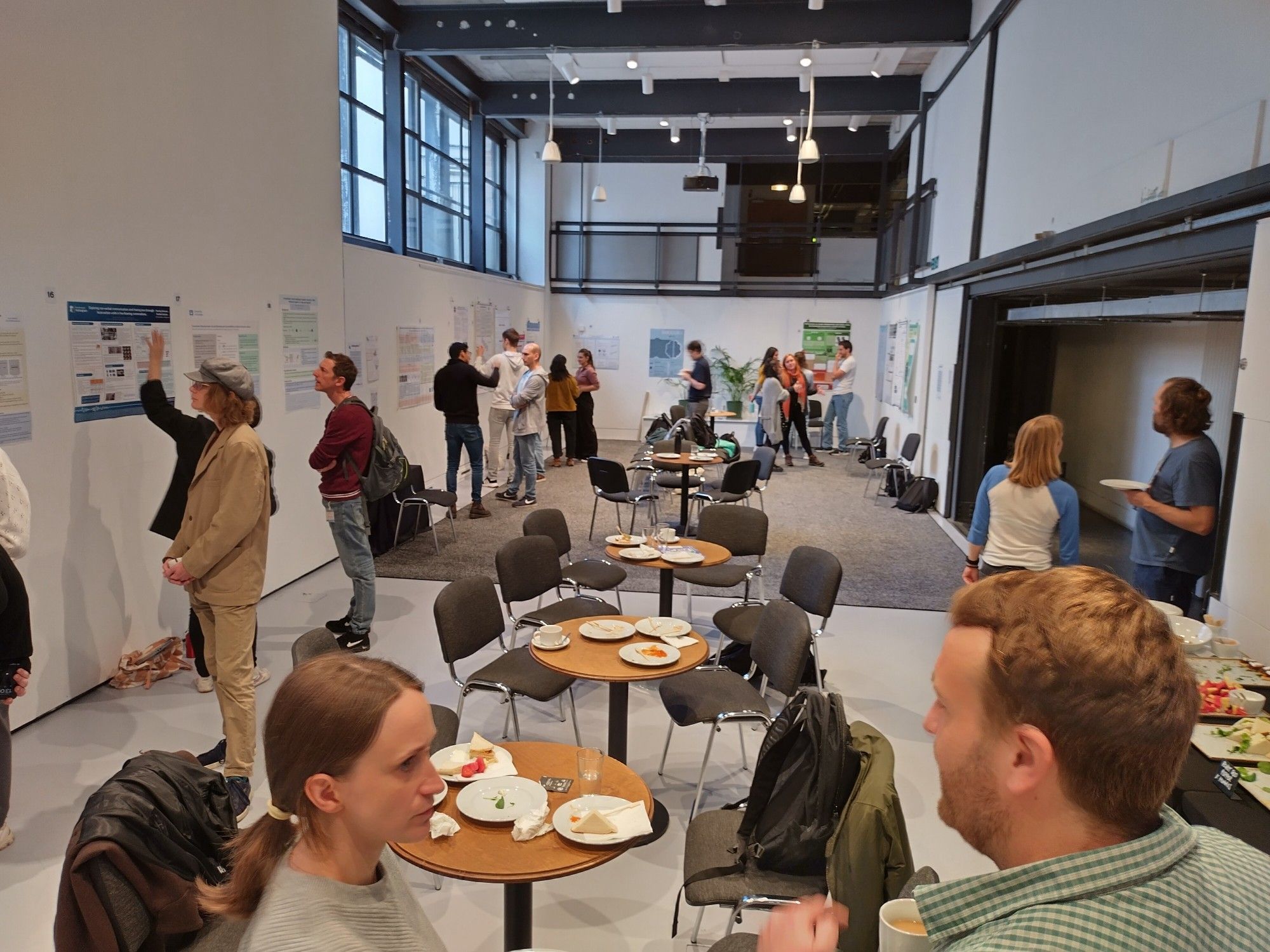 People viewing and discussing research posters.