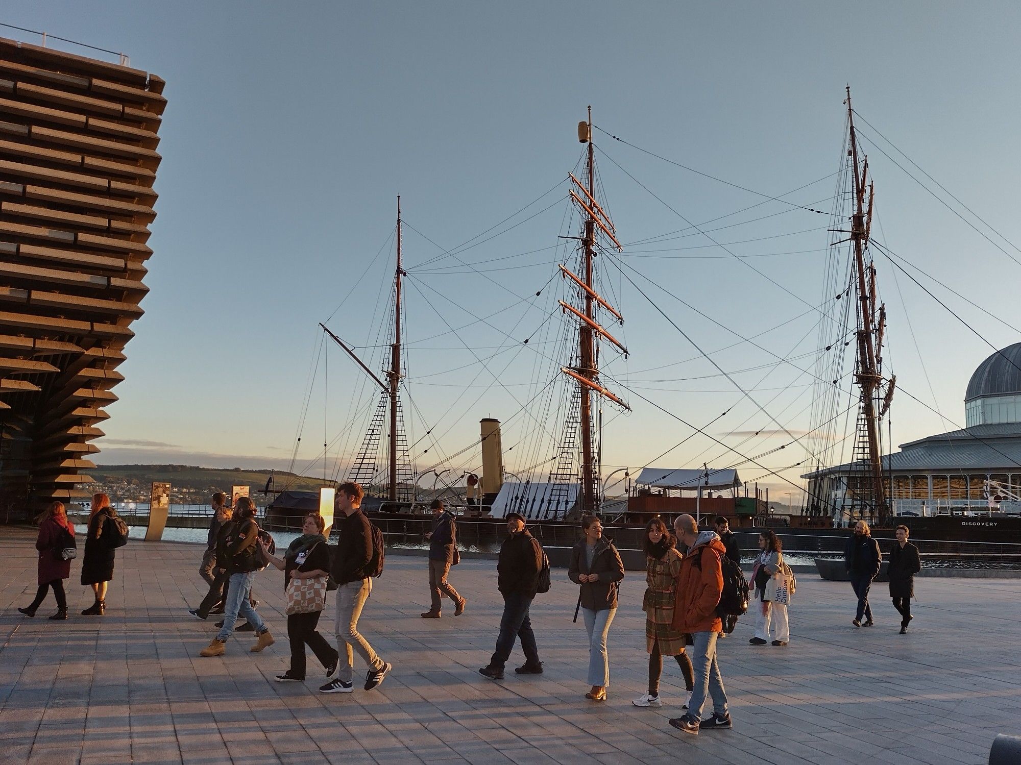 People walking past the Dundee waterfront.