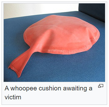 Wikipedia image of a whoopee cushion with the caption "A whoopee cushion awaiting a victim"