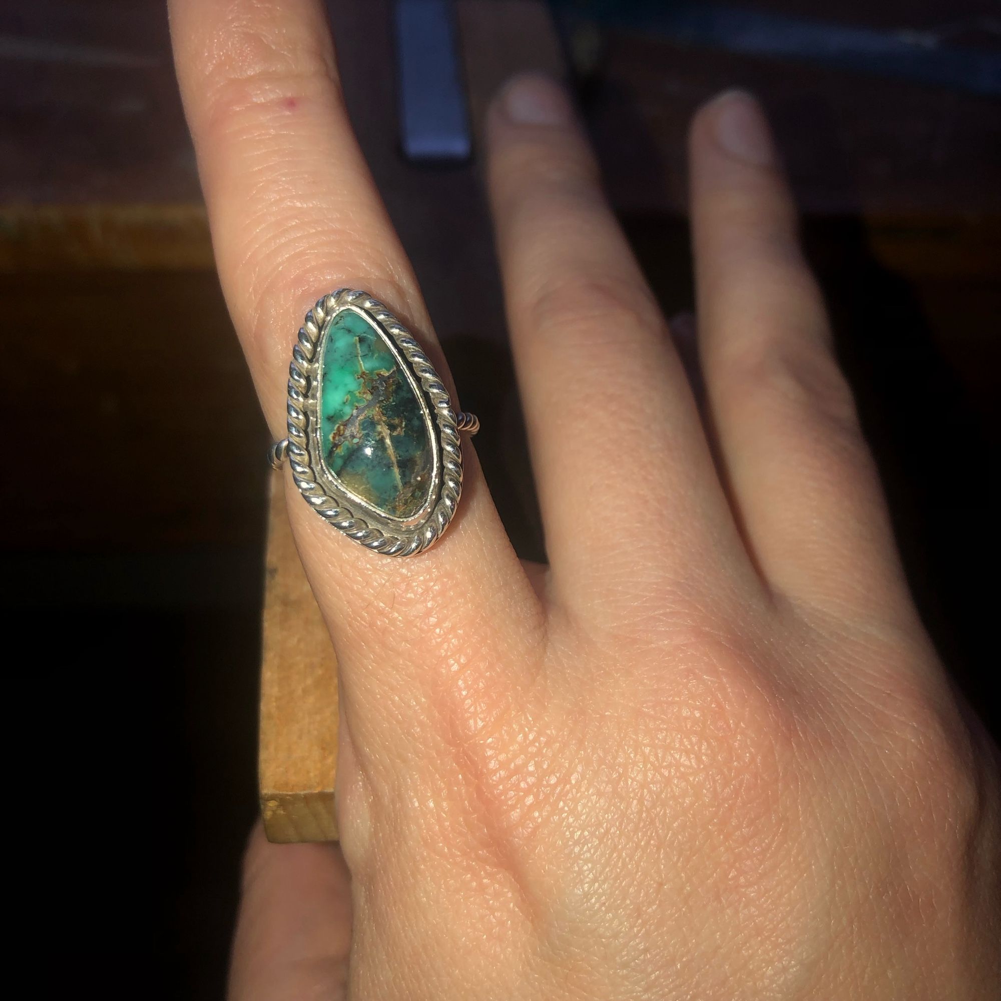 A silver ring with a green stone. (I forgot the name)