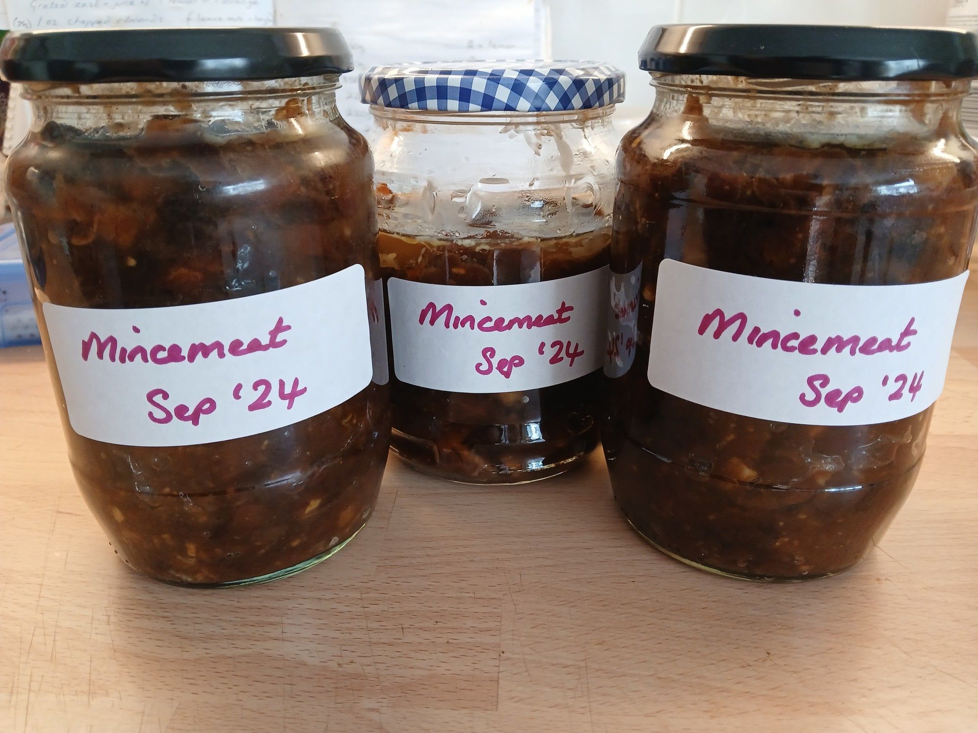 Three large jars containing homemade mincemeat, labelled 'Mincemeat - Sep '24'