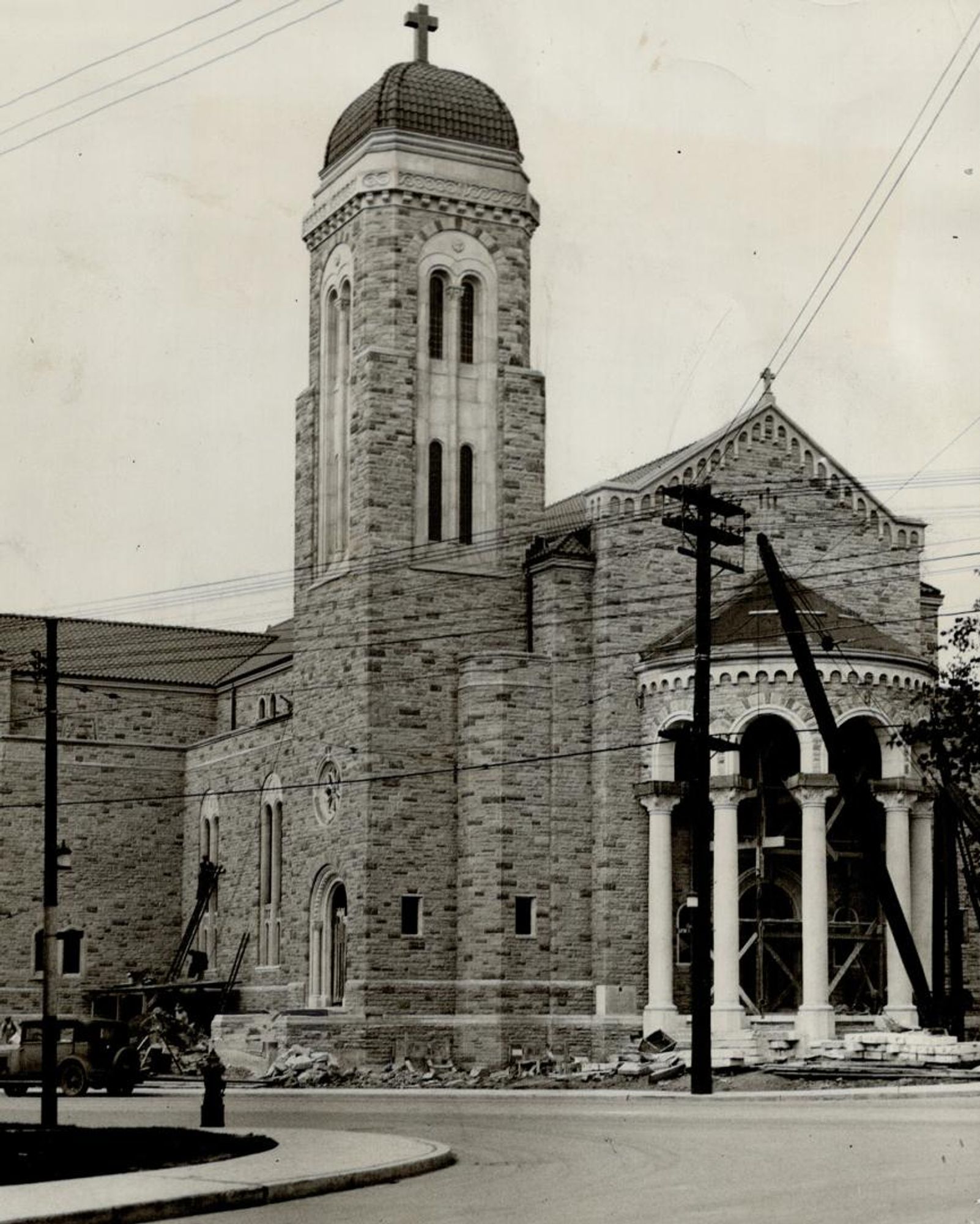 Black and white photo of a church nearing completion.