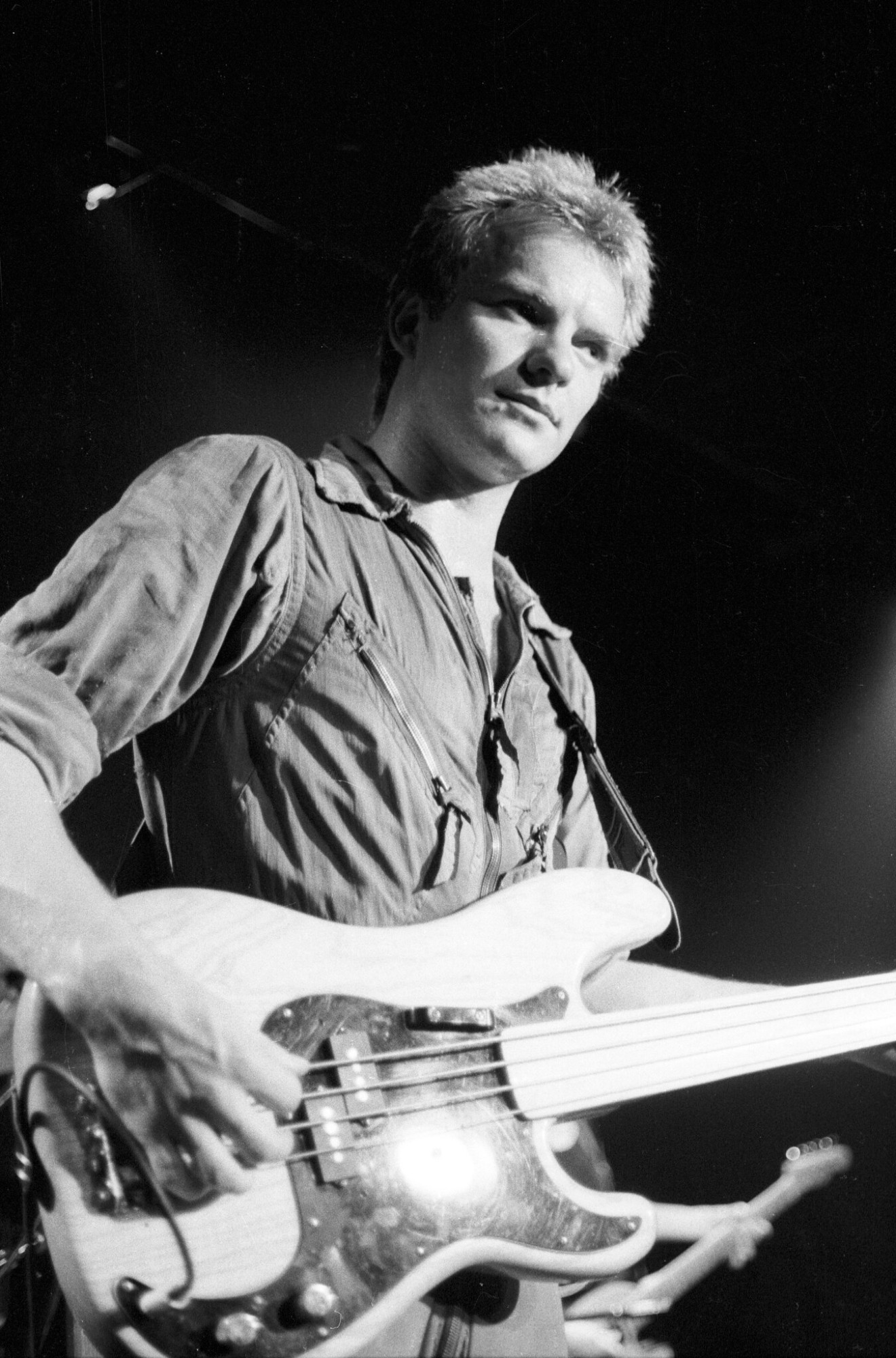 Black and white photo by Patrick Cummins of Sting playing bass guitar on stage in 1979 Toronto.