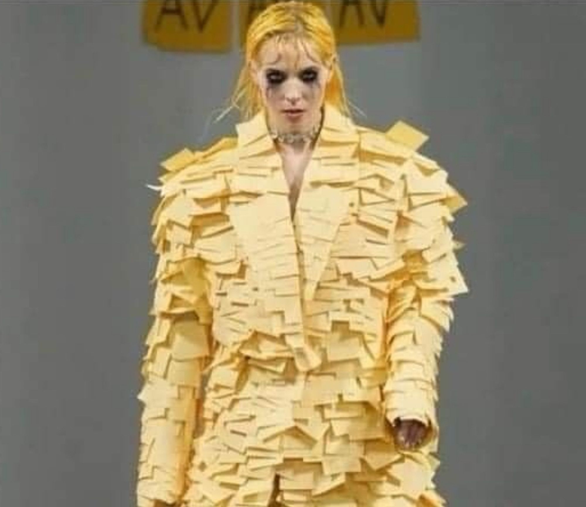 A person decked out in a suit made entirely of yellow sticky notes