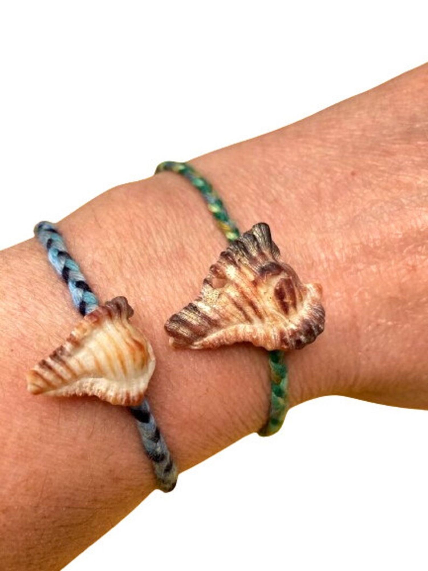 2 seashell handmade bracelets, one blue one green with a shell in the shape of a cobra head